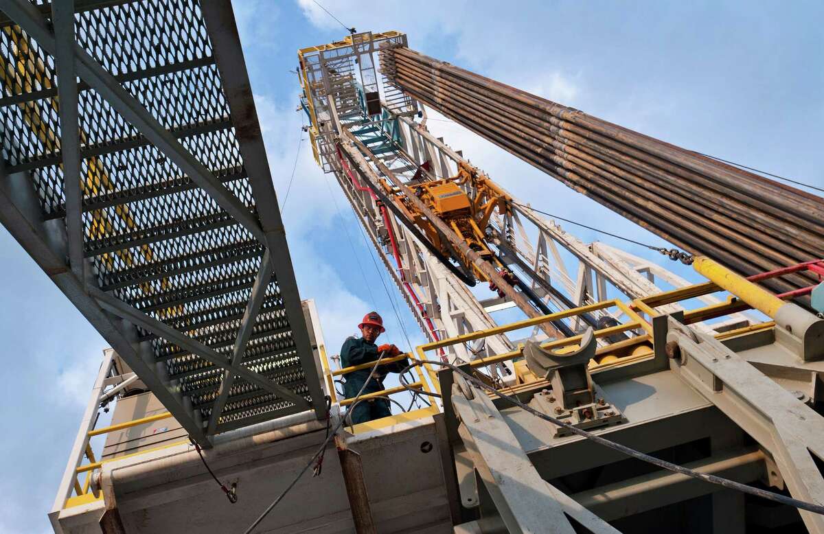 Floor hand Alejandro Cabanas handles a line on Orion Drilling's Perseus rig near Encinal in Webb County this spring. A study says the Eagle Ford Shale provided 47,097 full-time jobs in 2011.