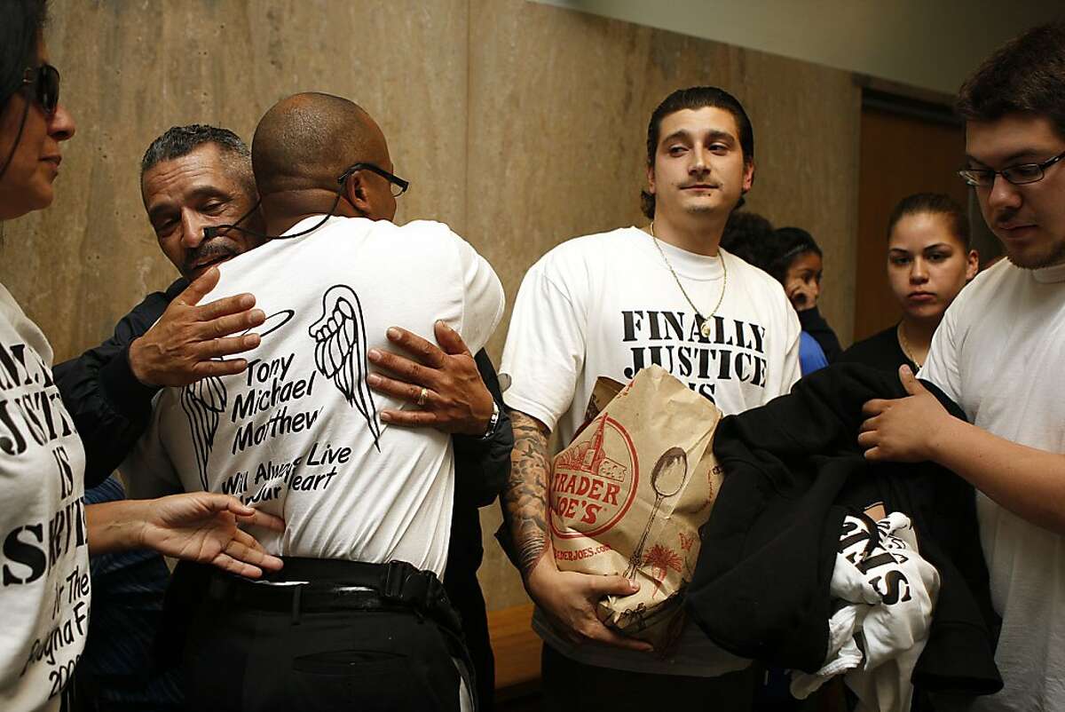 Friends of the Bologna family Reggie Hamilton (left) and Maverick Bishop (middle, right) don their shirts at the Hall of Justice in San Francisco, Calif., after the Ramos verdict on Wednesday, May 10, 2012. Edwin Ramos, 25, was convicted today of the mistaken-identity murders of her San Francisco husband and his two sons.