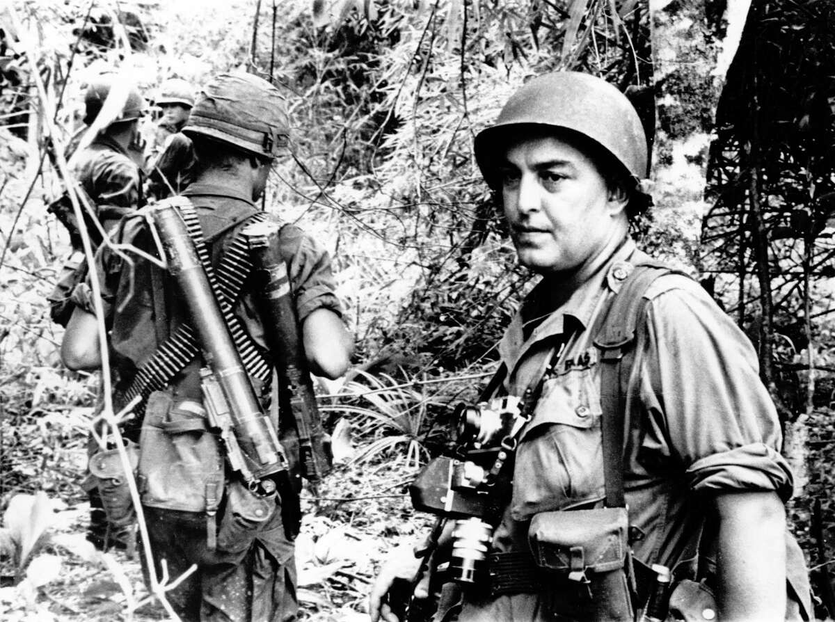 In this undated file photo, Associated Press photographer Horst Faas is shown on assignment with soldiers in South Vietnam. Faas, a prize-winning combat photographer who carved out new standards for covering war with a camera and became one of the world's legendary photojournalists in nearly half a century with The Associated Press, died Thursday May 10, 2012. He was 79.
