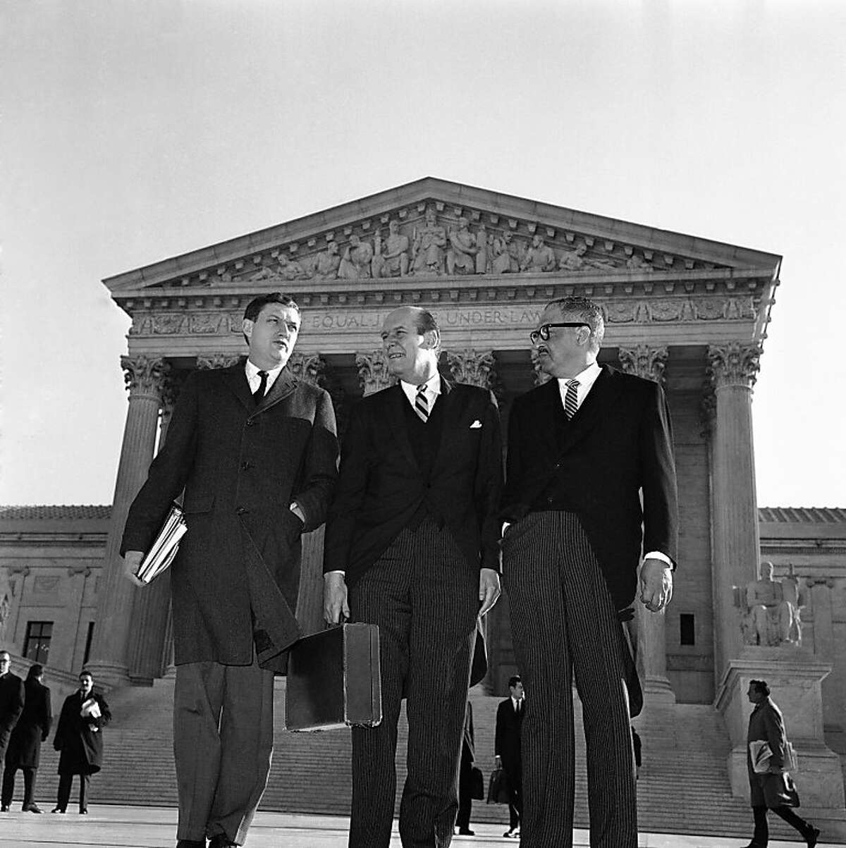 FILE - In this Jan. 17, 1966 file photo, Attorney General Nicholas Katzenbach, center, stands with Solicitor General Thurgood Marshall, left, and Assistant Attorney General John Doar as he arrives at the Supreme Court Building in Washington to defend the legality of the 1965 Voting Rights Act. Katzenbach, who held influential posts in the Kennedy and Johnson administrations and played a prominent, televised role in federal desegregation efforts in the South, died Tuesday, May 8, 2012. He was 90. (AP Photo)