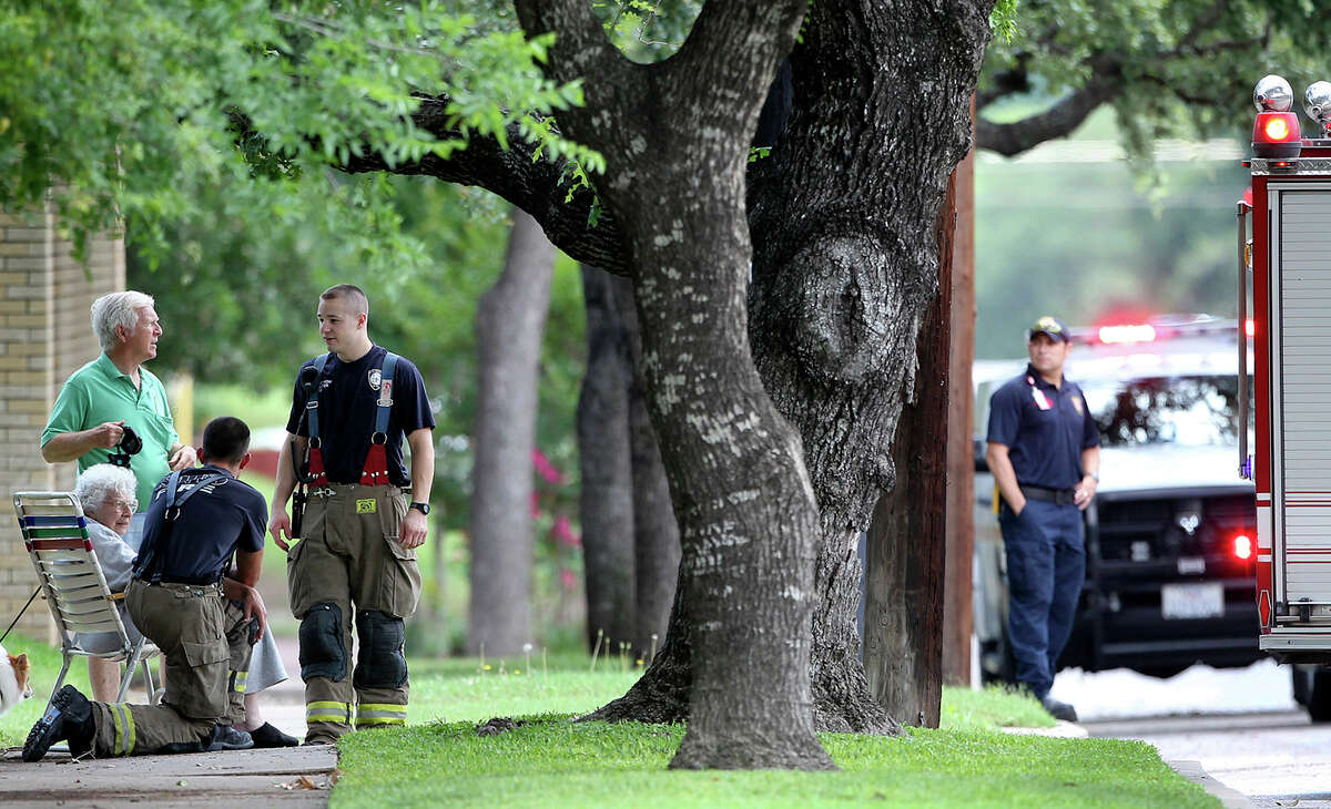METRO Neighbors talk with firefighters as a suspicious package is removed by authorities from an alleyway near the intersection of Howard and W. Grammercy on May 11, 2012. Tom Reel/ San Antonio Express-News