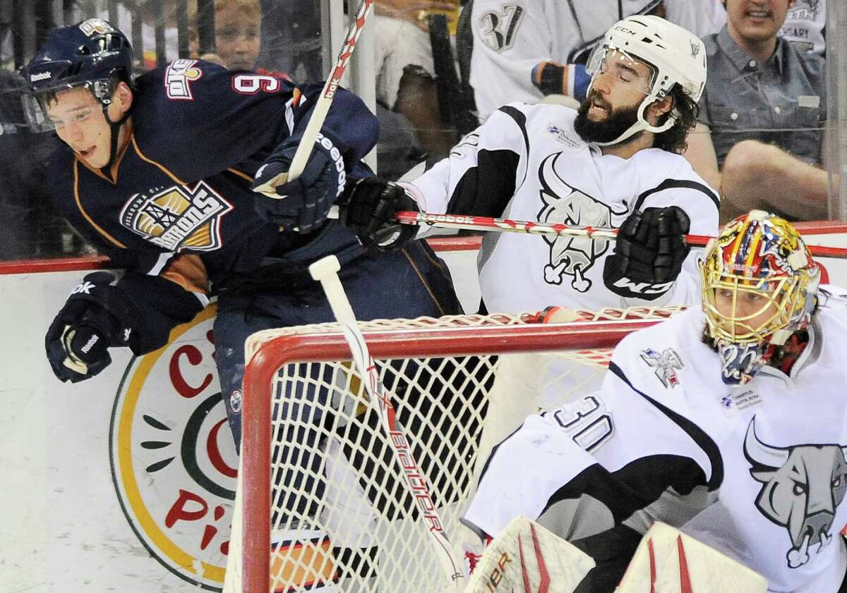 San Antonio Rampage's Scott Timmins, right, puts Oklahoma City Barons' Tyler Pitlick into the glass during the second period of an AHL hockey game, Friday, May 11, 2012, in San Antonio.