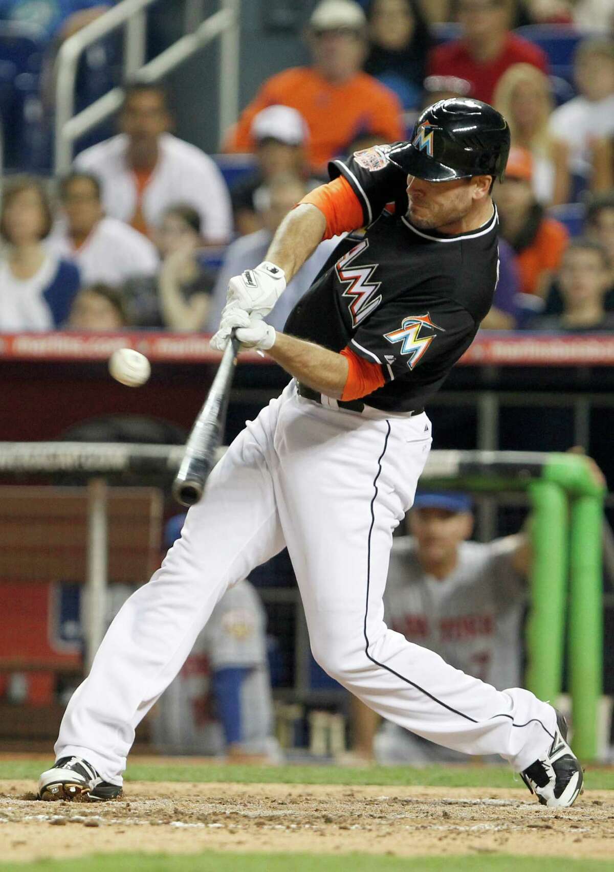 Miami Marlins' Greg Dobbs hits a single to score Emilio Bonifacio for the win during the ninth inning of a baseball game against the New York Mets, Friday, May 11, 2012, in Miami. The Marlins defeated the Mets 6-5.