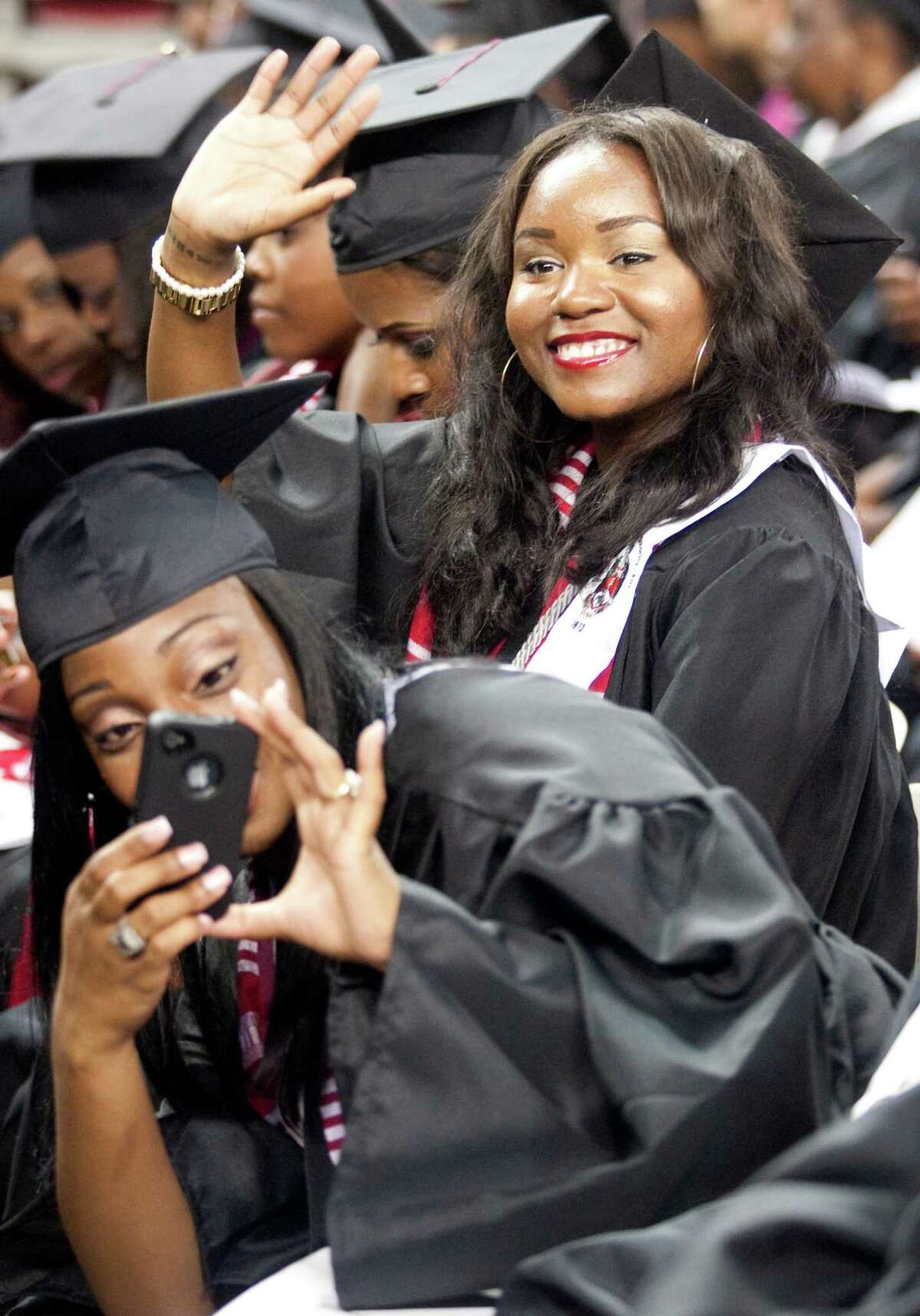 Kim Roberts takes a picture while Jylise Smith waves to friends during graduation ceremonies at Texas Southern University on Saturday, May 12, 2012 in Houston, Texas.