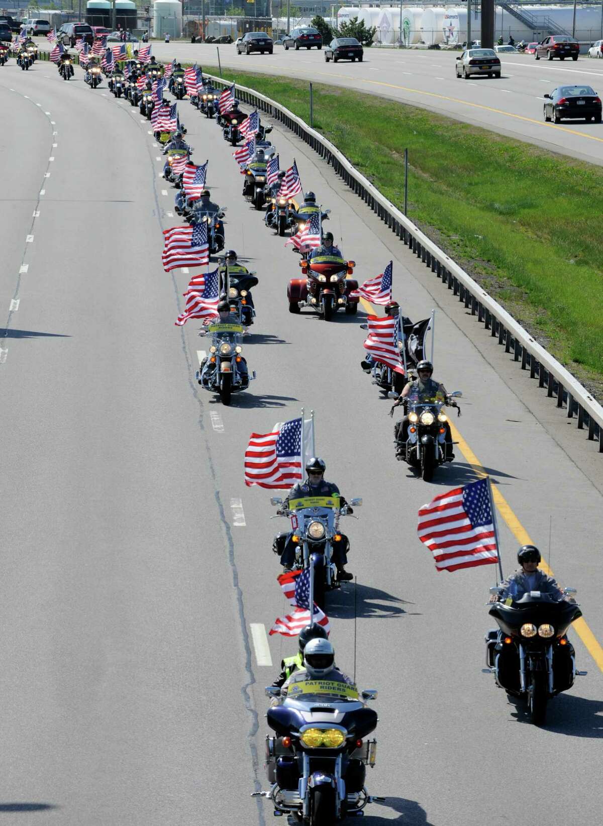 Patriot riders on motorcycles lead the funeral procession of U.S. Army nurse Capt. Bruce Kevin Clark who died in Afghanistan following Military honors at Rochester International Airport Saturday, May 12, 2012.