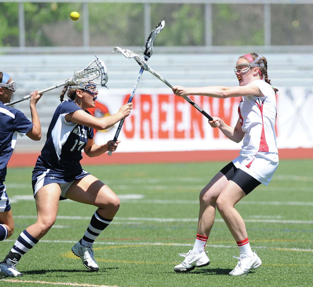Claire Feeney, right, of Greenwich, scores a first half goal during the girls high school lacrosse match between Wilton High School and Greenwich High School at Greenwich, May 12, 2012. Wilton won the match 18-9. Covering on the play for Wilton is Liz Reda # 17.