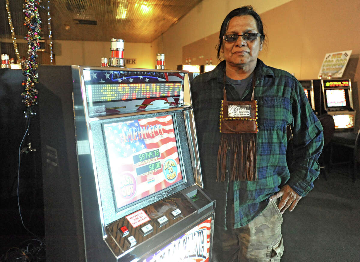 Thomas Square stands by a slot machine at Three Feathers Casino on the Akwesasne Reservation Tuesday April 24, 2012 in Hogansburg, N.Y. Square worked at Ganienkeh in the past and says its casino is not authorized by the traditional Mohawk leaders. (Lori Van Buren / Times Union)