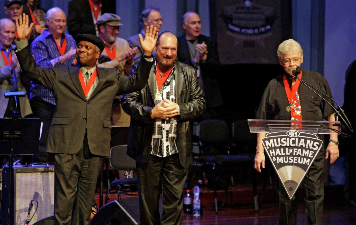 FILE - In this Oct. 28, 2008 file photo, Booker T. Jones, left, Steve Cropper, center, and Donald "Duck" Dunn, right, of the group Booker T. & the MGs, acknowledge the applause as they are inducted into the Musicians Hall of Fame in Nashville, Tenn. Bass player and songwriter Dunn died in Tokyo, Sunday May 13, 2012. He was 70. (AP Photo/Mark Humphrey, File)