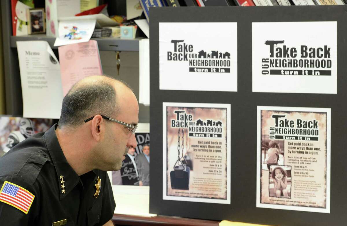 Schenectady County Sheriff Dominic Dagostino looks over comps for the gun buyback program for Schenectady County at his office in Schenectady, N.Y., May 10, 2012. (Skip Dickstein / Times Union)