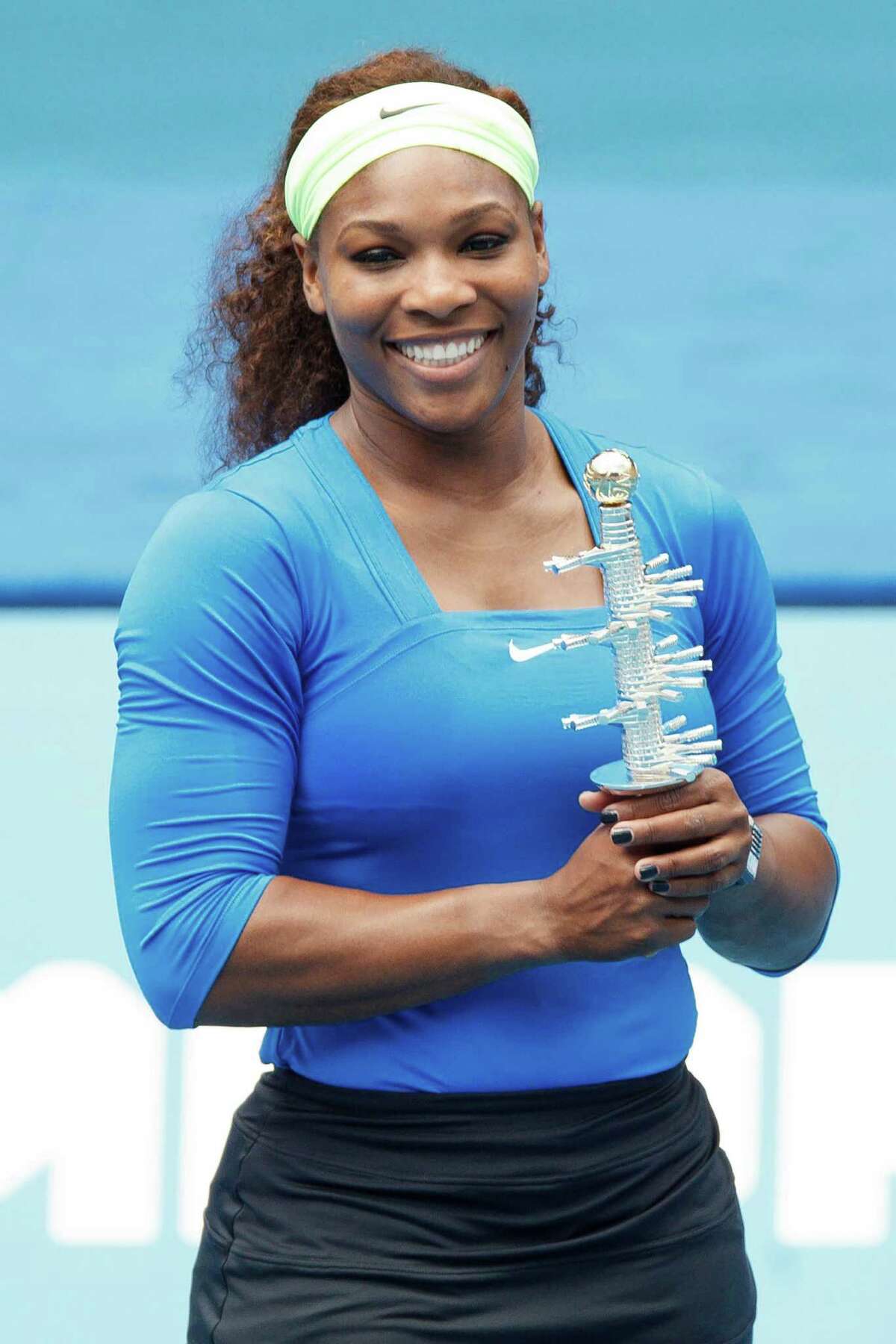 Serena Williams from U.S. holds the trophy after defeating Victoria Azarenka from Belarus in their singles women's final tennis match at the Madrid Open tennis tournament in Madrid Sunday, May 13, 2012. (AP Photo/Daniel Ochoa de Olza)