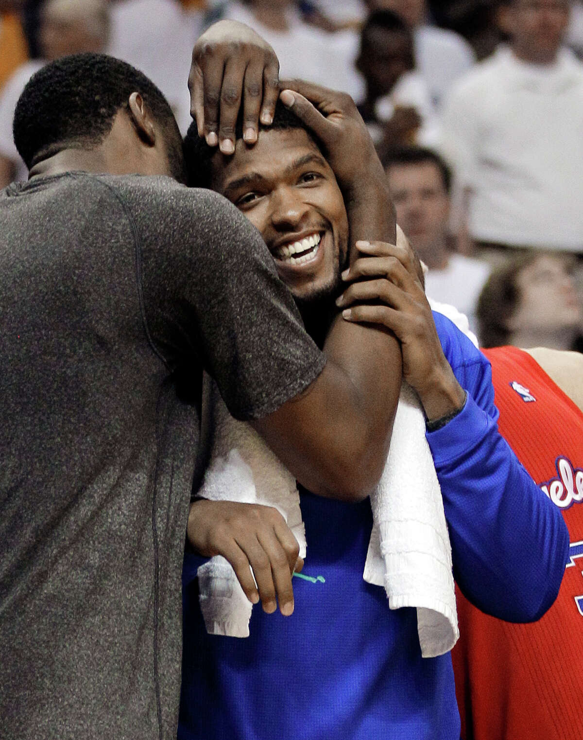 Los Angeles Clippers center DeAndre Jordan, left, hugs teammate Ryan Gomes, right, in final seconds of the second half of Game 7 against the Memphis Grizzlies in a first-round NBA basketball playoff series on Sunday, May 13, 2012, in Memphis, Tenn. The Clippers won 82-72 to take the series 4-3. (AP Photo/Mark Humphrey)