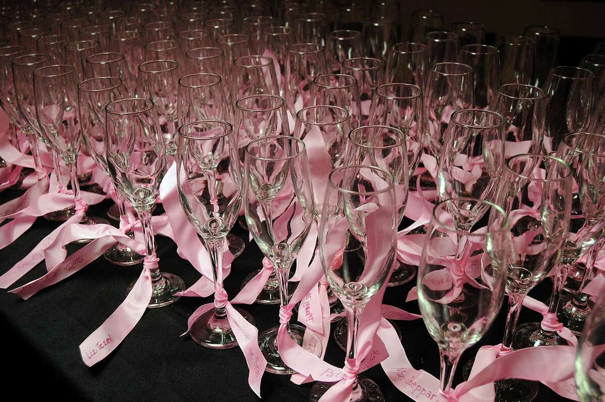 Champagne glasses adorned with pink ribbons at the "Pink at the Brown" fund raiser for the Pink Ribbons Project at the Wortham Theater Thursday May 10,2012. (Dave Rossman Photo)