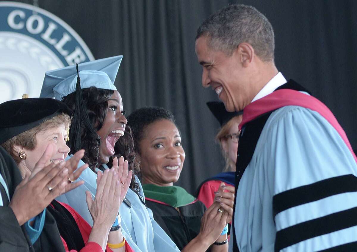 President Barack Obama greets graduate Britney Wilson on Monday before making the commencement address at Barnard College. He did not directly criticize Mitt Romney at the speech.
