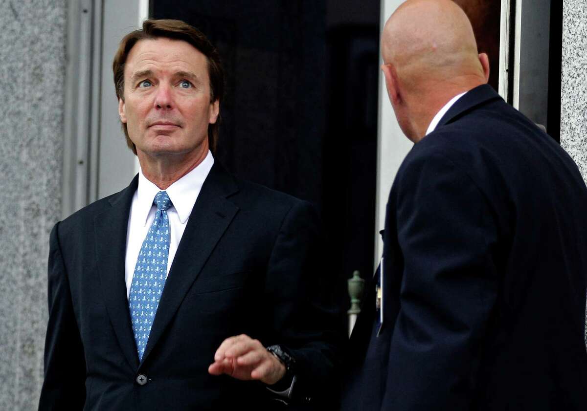 FILE - In this May 8, 2012 file photo, former presidential candidate and Sen. John Edwards, left, leaves a federal courthouse in Greensboro, N.C. Lawyers for Edwards are set to begin presenting his defense at the former presidential contender?s conspiracy and campaign-finance trial on Monday, May 14, 2012. (AP Photo/Chuck Burton, File)