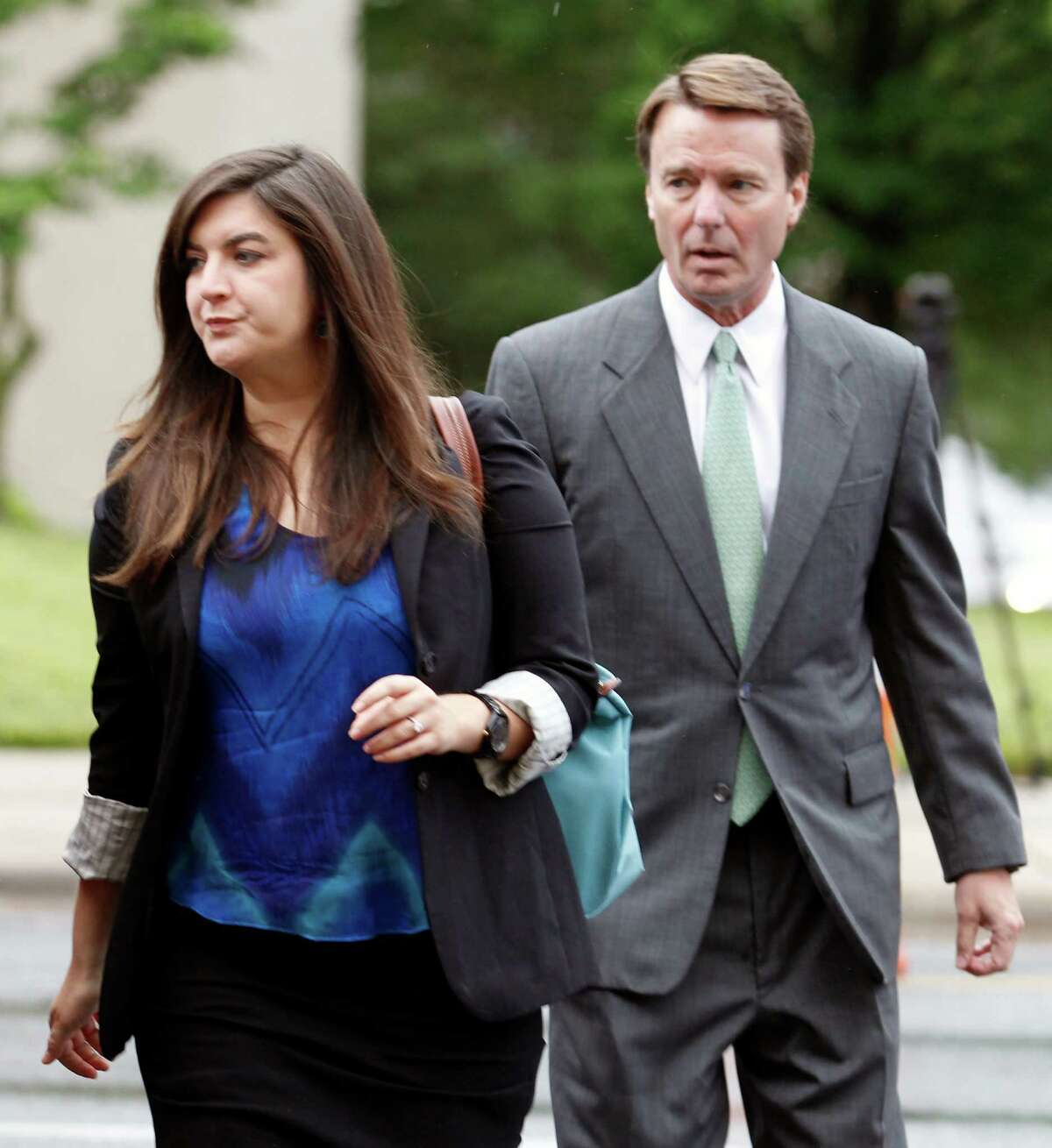 Cate Edwards leads her father, John Edwards, into the federal courthouse in Greensboro, N.C., as the defense starts in his campaign corruption trial, Monday, May 14, 2012. (AP Photo/Bob Leverone)