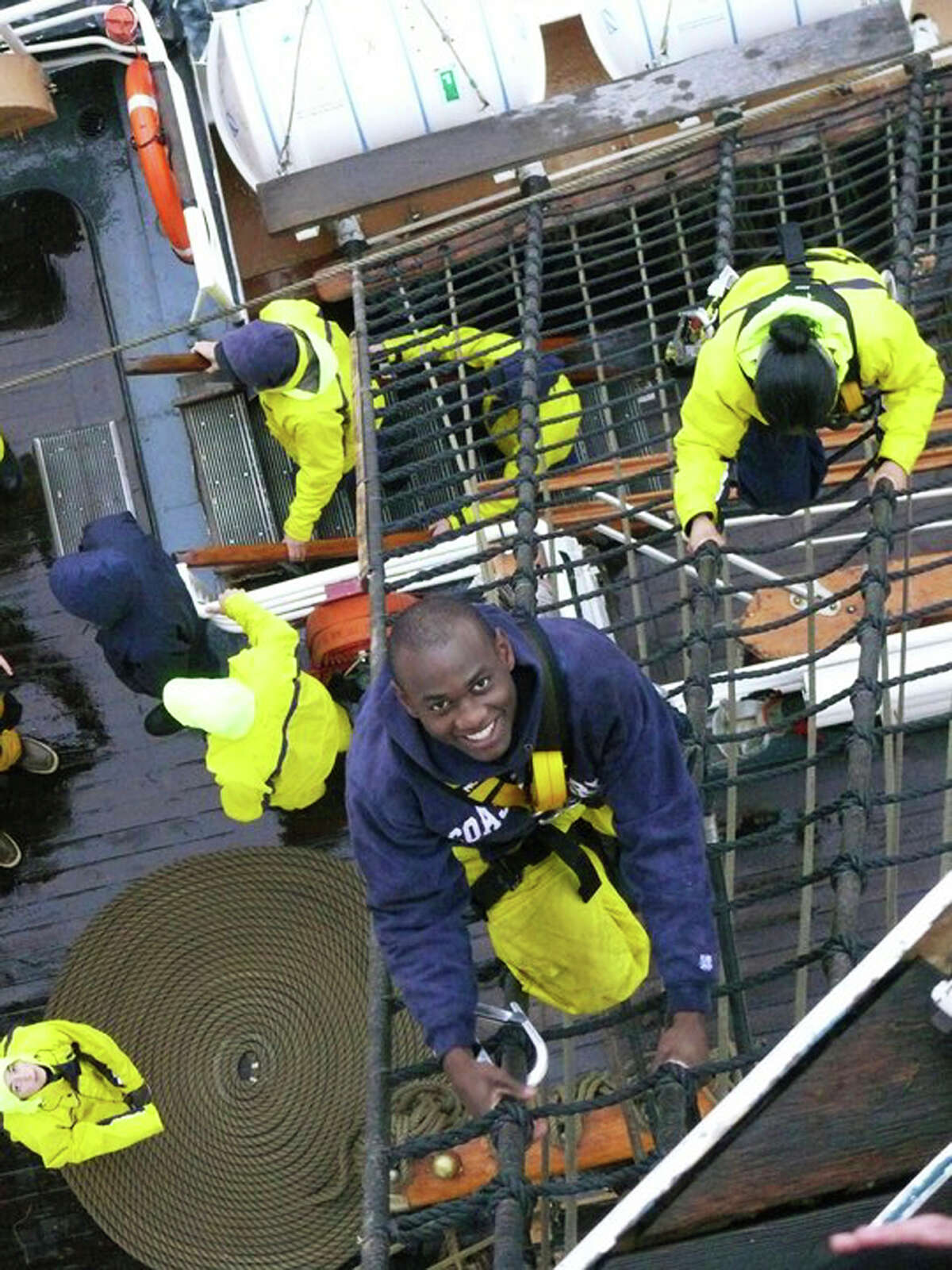 In this May 25, 2011 photo provided by the U.S. Coast Guard, U.S. Coast guard Academy, 1st Class, Cadet Orlando Morel climbs rigging aboard the Coast Guard Cutter Eagle. Morel was 6 years old when he and his mother were rescued by the Coast Guard while leaving Haiti. Morel, now of Rockville, Md., will graduate Wednesday, May 16, 2012, from the Coast Guard Academy in New London, Conn. (AP Photo/U.S. Coast Guard Academy)
