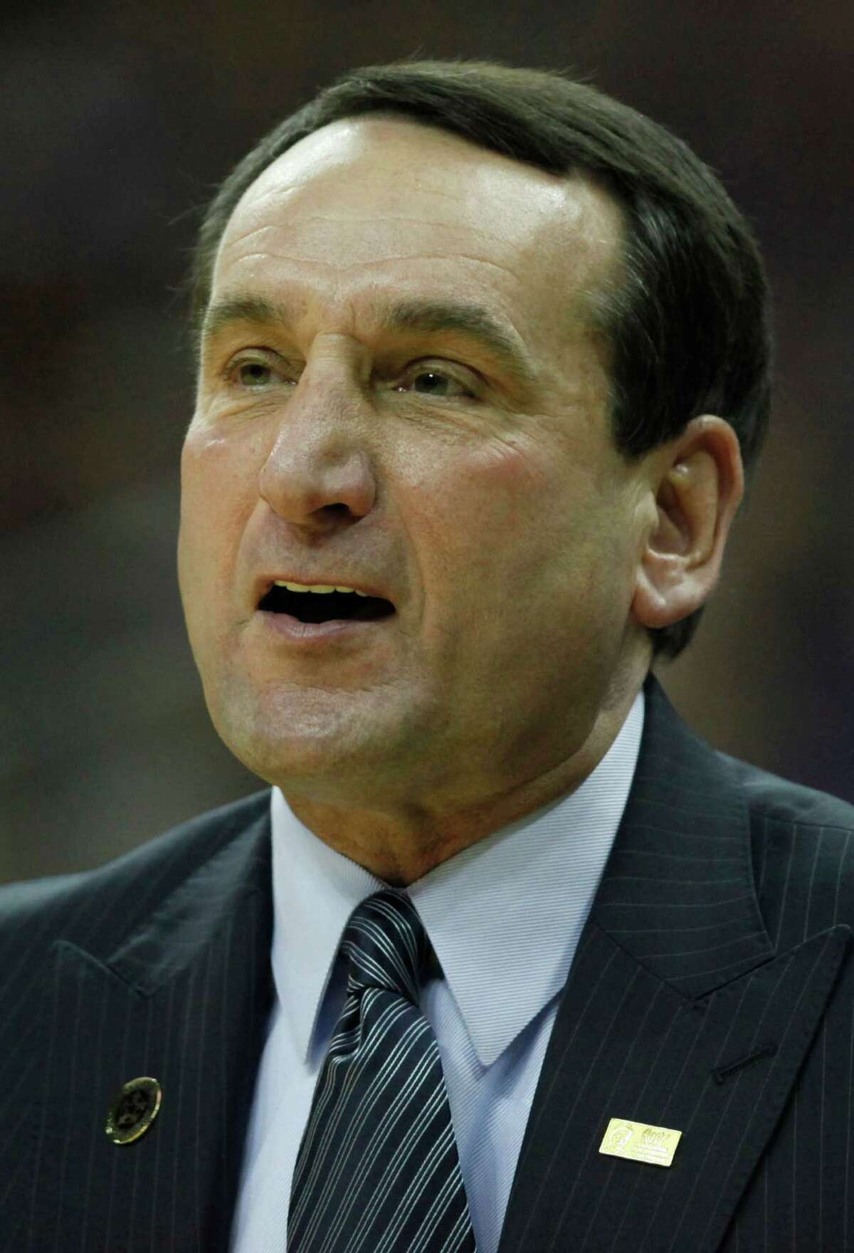 FILE - This Nov. 23, 2010, file photo shows Duke coach Mike Krzyzewski during an NCAA college basketball game against Kansas State, in Kansas City, Mo. These days, nobody who bleeds Duke blue wants Krzyzewski out anytime soon _ especially now that he's about to pass rival Dean Smith on the all-time wins list. (AP Photo/Charlie Riedel, File)