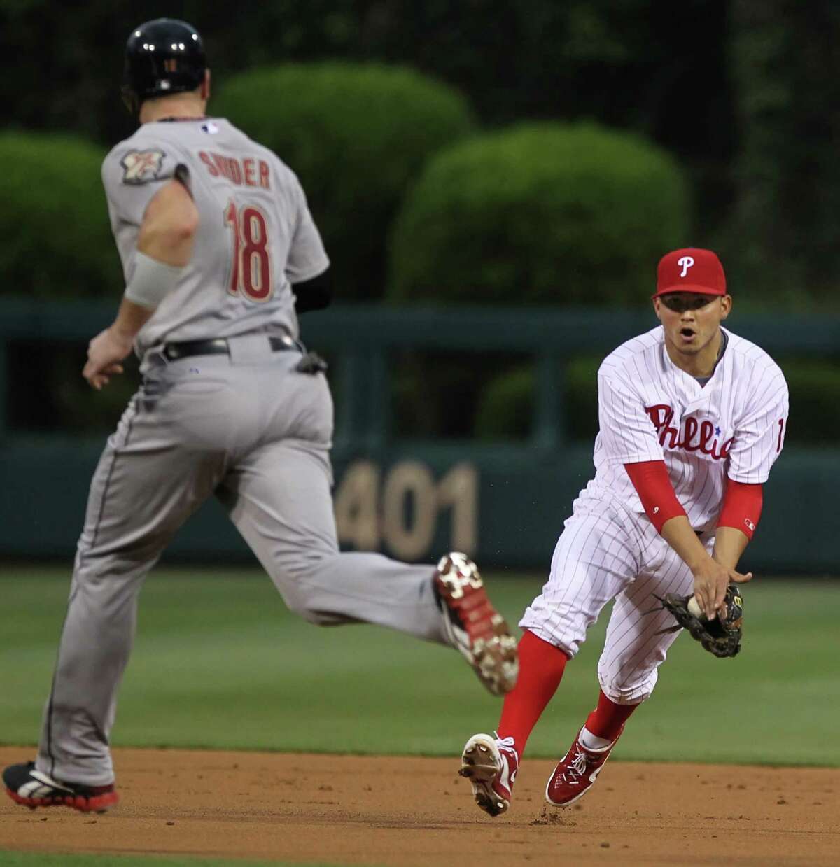 Another scoreless inning for the Astros goes in the books as Phillies second baseman Freddy Galvis, right, handles a grounder by Lucas Harrell to strand Chris Snyder (18) in the second inning Monday night.
