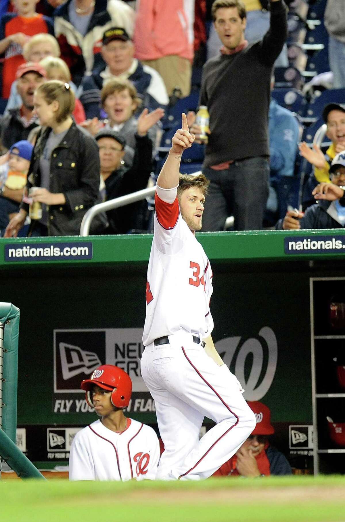 Nationals rookie Bryce Harper takes a curtain call for fans after hitting his first career home run in the third inning of Monday's game against San Diego.