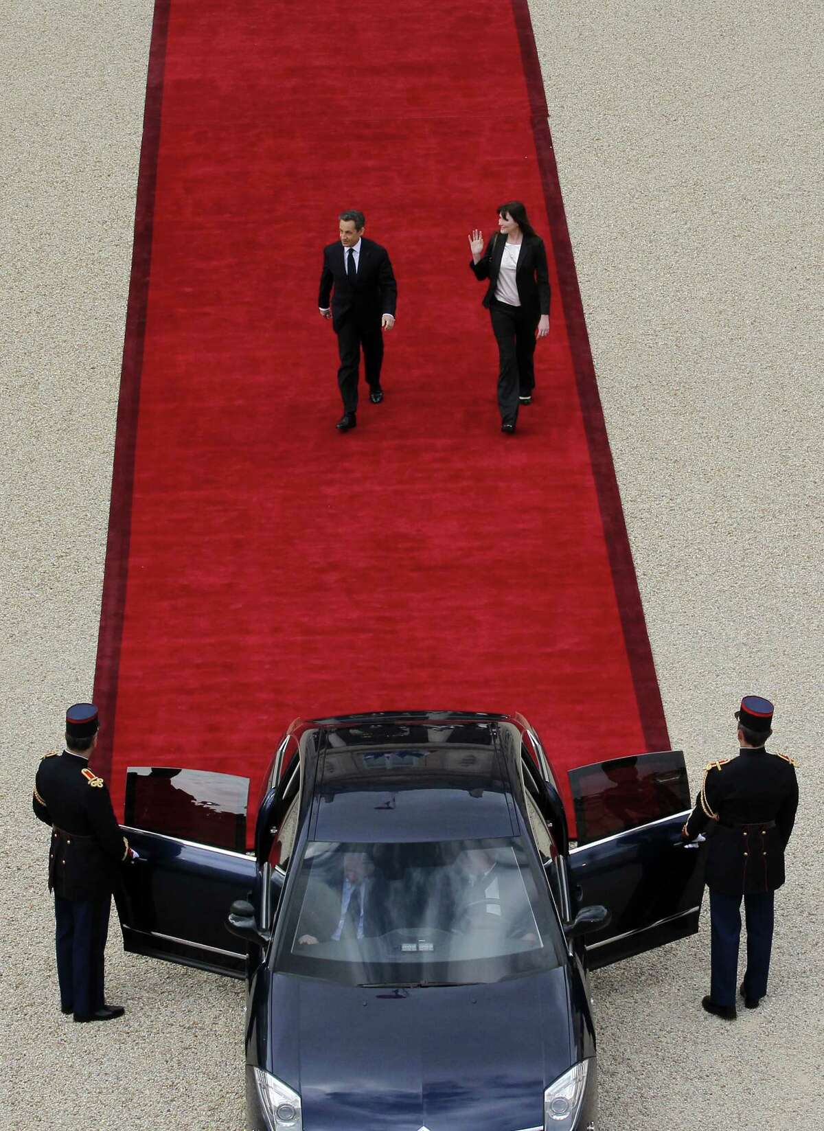 Former France's president Nicolas Sarkozy (L) and his wife Carla Bruni-Sarkozy leave the Elysee presidential Palace after the formal investiture ceremony between France's president-elect Francois Hollande and his predecessor Nicolas Sarkozy, on May 15, 2012 in Paris.