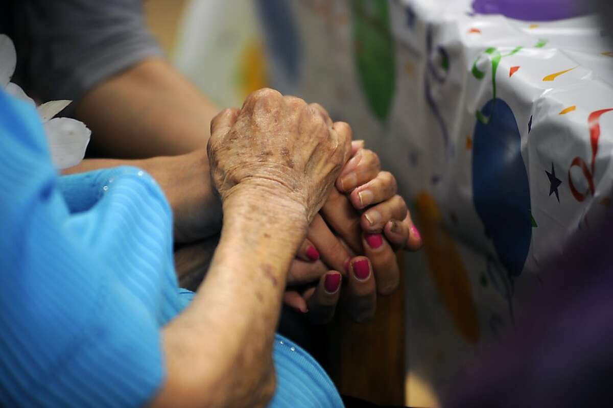 Dominga Velasco holds hands with her great grandaughter Erika Latour. Dominga turned 111 years old at the Posada De Colores nursing home in Oakland, CA Monday May 14th, 2012