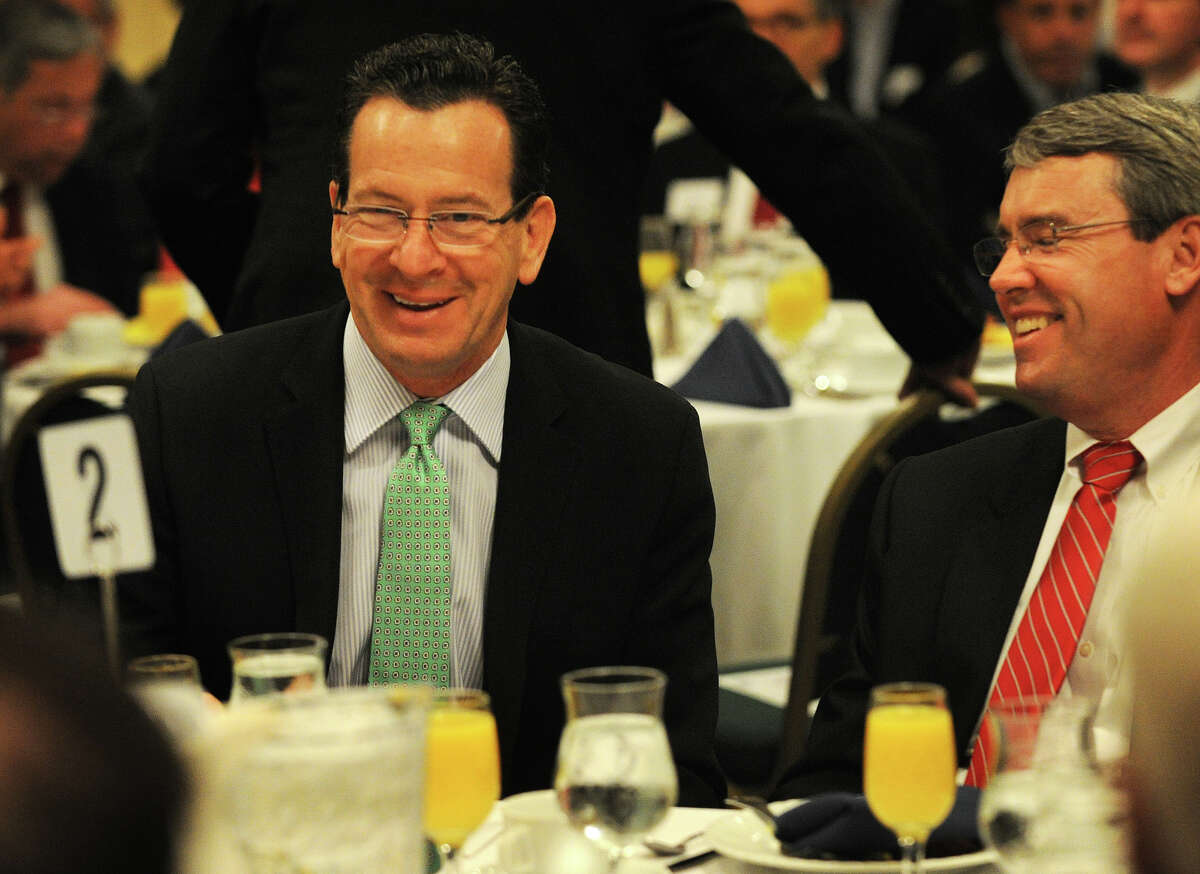 Gov. Dannel P. Malloy, left, sits with People's United Financial Inc. CEO and President Jack Barnes, right, at the Bridgeport Regional Business Council's Capital Breakfast at the Holiday Inn in Bridgeport on Tuesday, May 15, 2012.