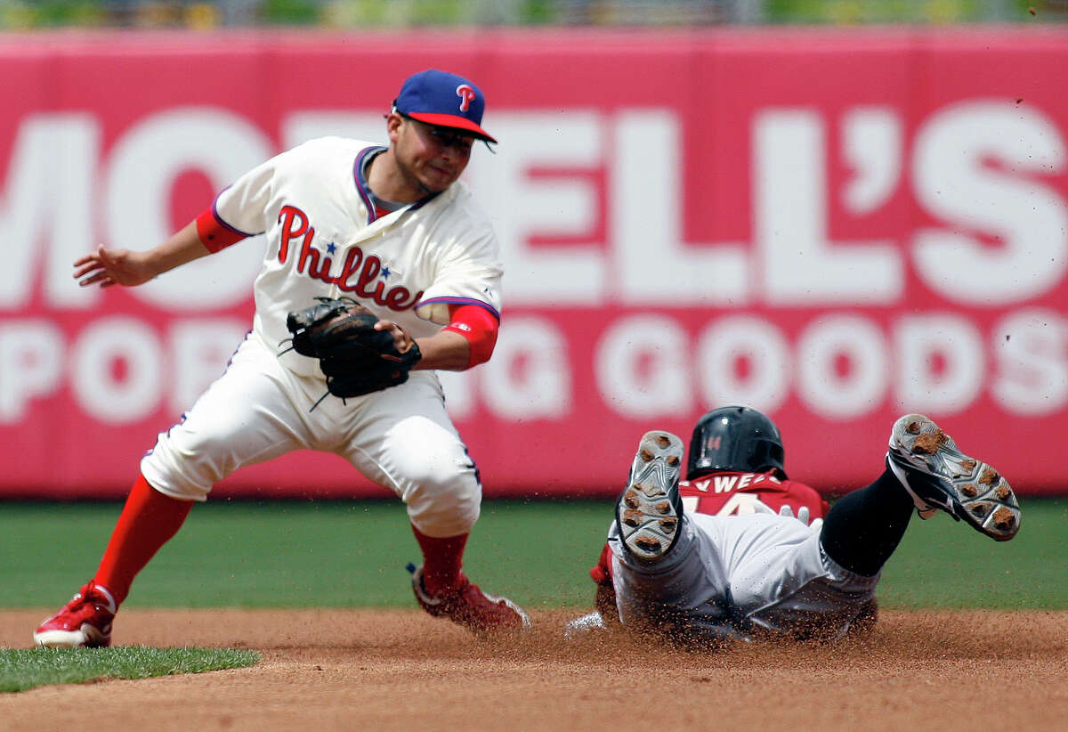 Philadelphia Phillies' Freddy Galvis, left moves to tag out Houston Astros' Justin Maxwell as Maxwell attempted to steal second base in the first inning of a baseball game, Tuesday, May 15, 2012, in Philadelphia. (AP Photo/H. Rumph Jr)