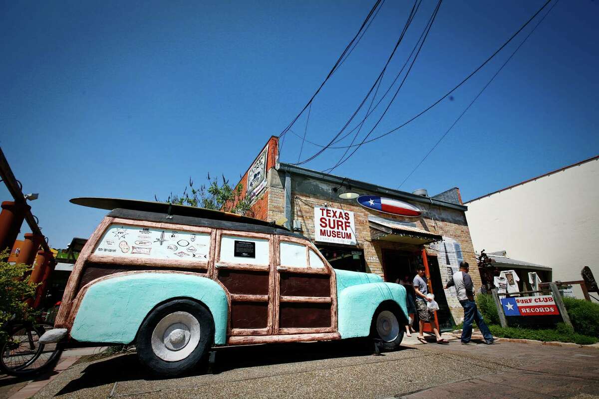 Visitors to the Texas Surf Museum are greeted by a sculpture of a Woody automobile.