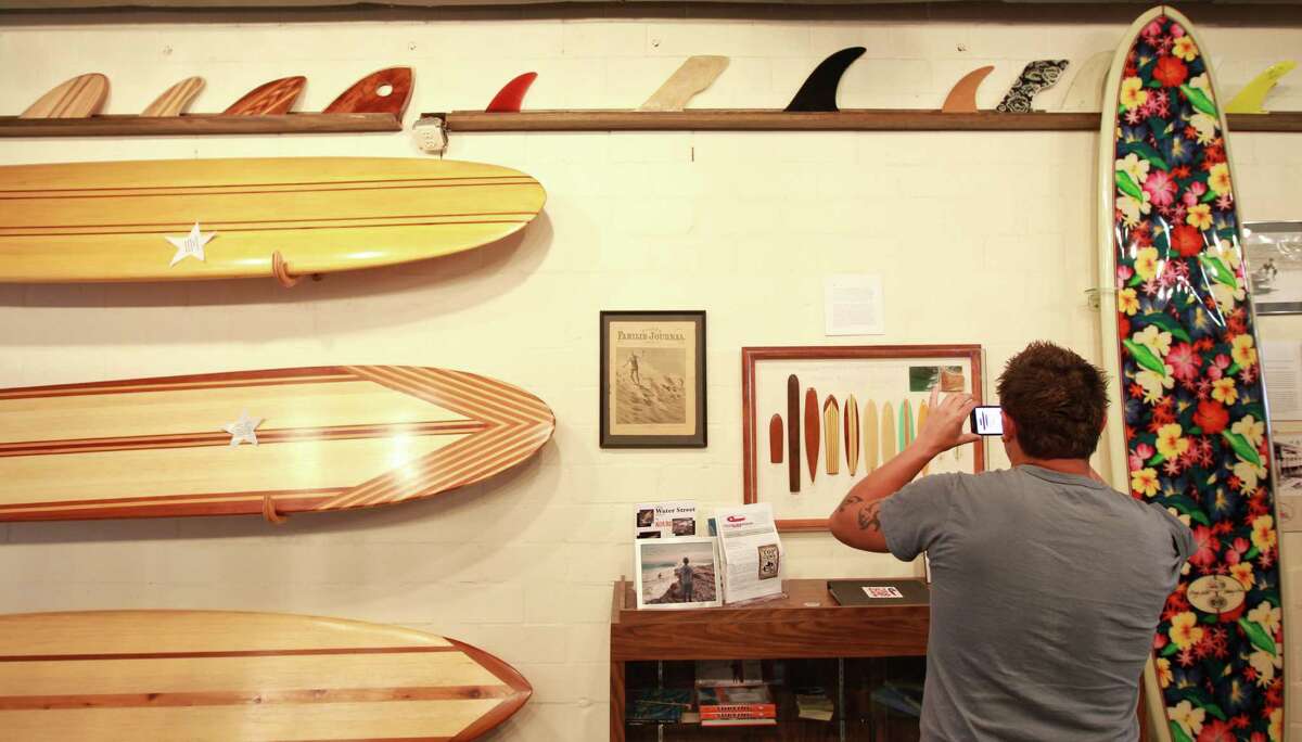 Marco Garza, of Corpus Christi makes a picture of the Texas Surf Museums surf board evolution exhibit, Saturday, March 24, 2012, in Corpus Christi. ( Nick de la Torre / Houston Chronicle )