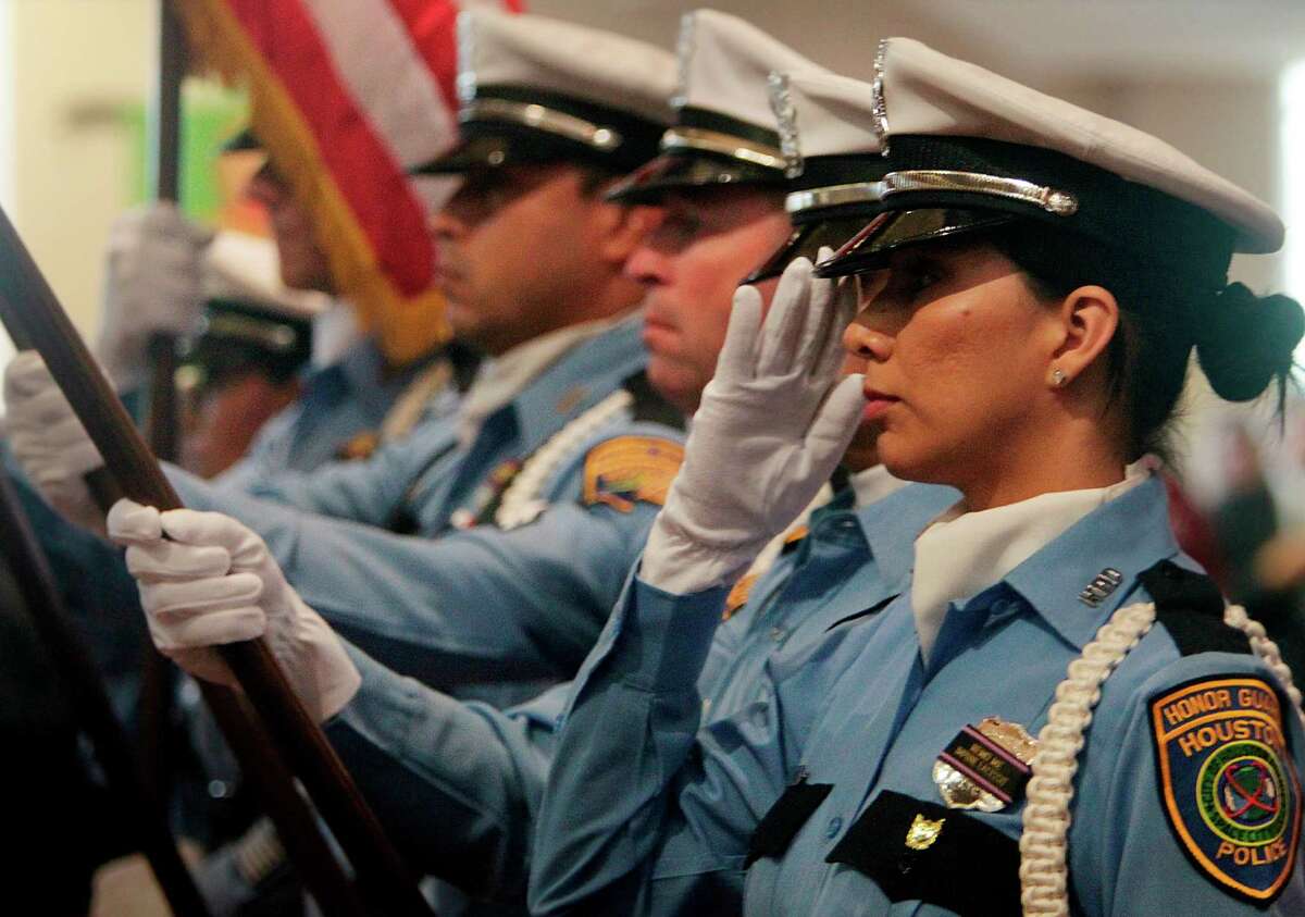 Houston Police Department Honor Guard Melsin Torres salutes while the National Anthem is sung during the FBI Law Enforcement Memorial Service.