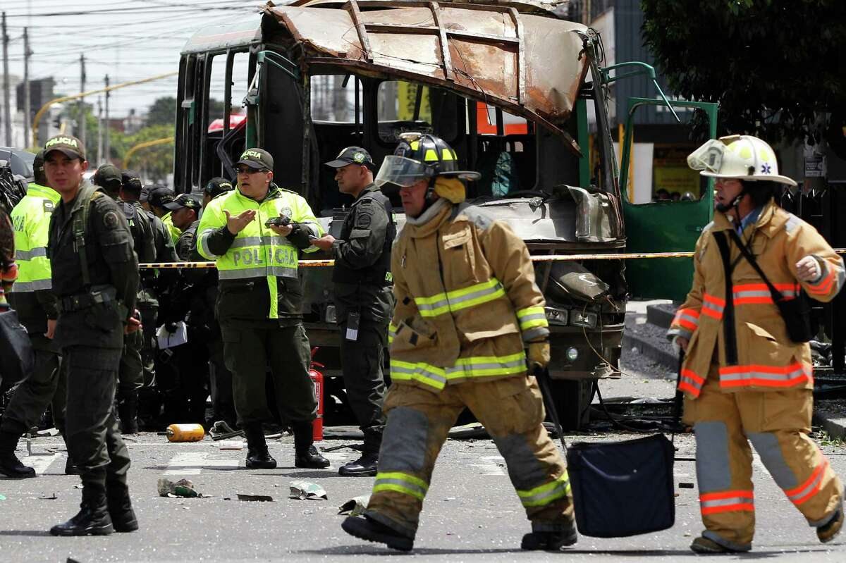 Police and firefighters work at the scene after a bomb exploded in Bogota, Colombia, Tuesday, May 15, 2012.