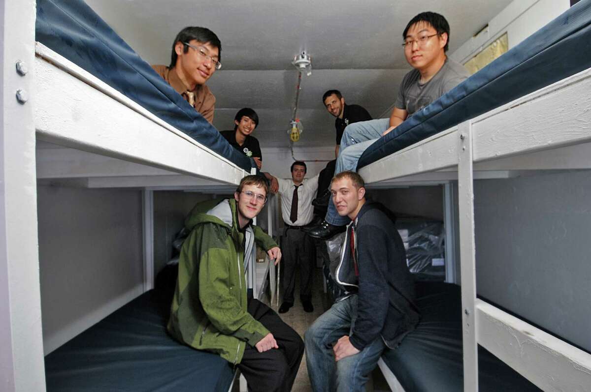 Members of the RPI student group Engineers for a Sustainable World are converting a used 20 foot long steel shipping container into living quarters that will be sent for use by the Orphanage of Good Will in Haiti, on Tuesday May 15, 2012 in Troy, NY. Top row left to right are senior Nelson Lim of Queens, junior Andrew Chung of Wilton, CT, senior Casey McEvoy of Newport, NY and senior Elliott Kim of Queens. Seated are David Hackett of Alburquerque, NM, left, and Kyle Gleken of Wolcott, NY, right. Standing at center is Dylan Martinez of New Fairfield, CT. (Philip Kamrass / Times Union )