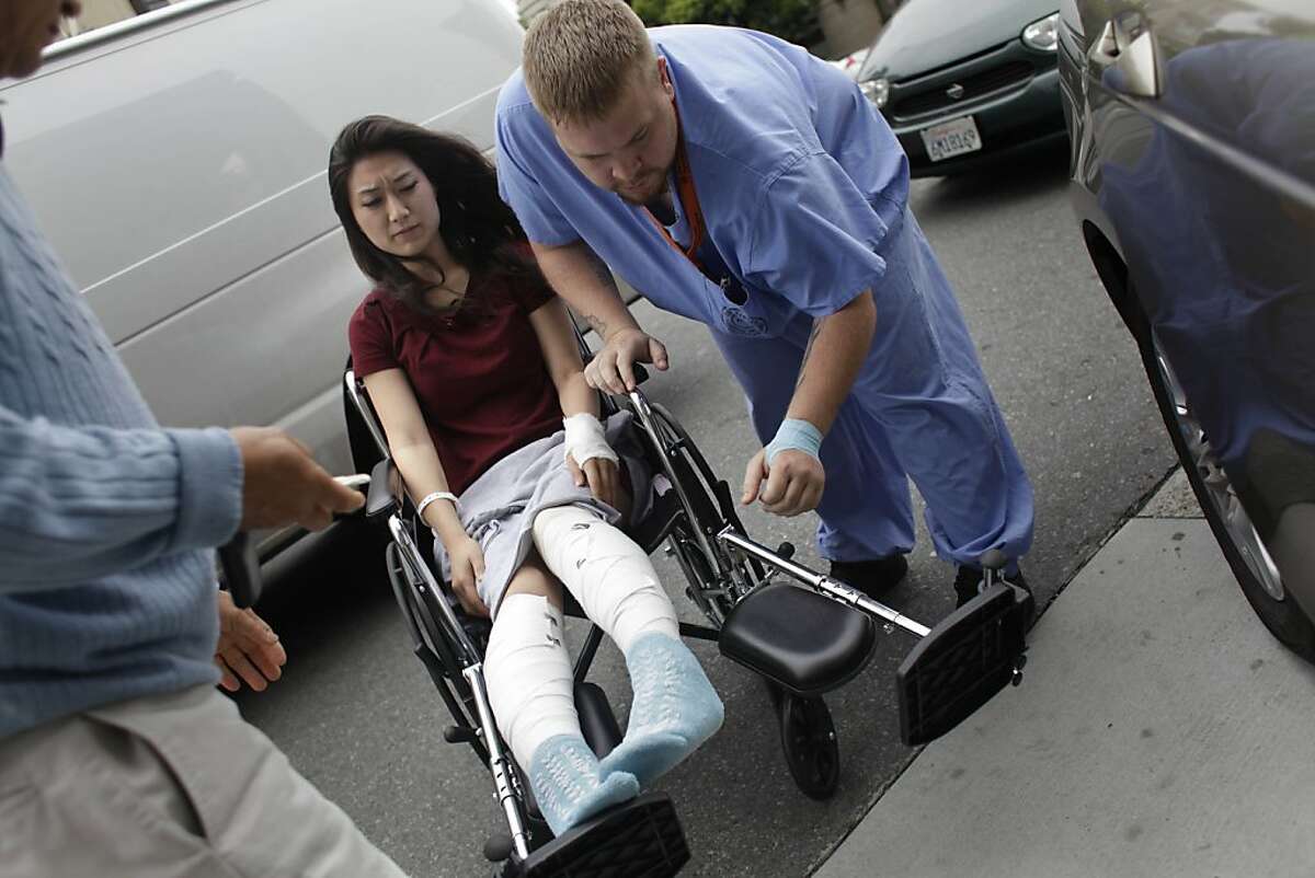 Shane Miller (right), transporter, helps Sara Choi (left) into her parents car as she leaves Saint Francis Memorial Hospital, where she was treated for burns suffered in an apartment fire, on Wednesday, May 16, 2012 in San Francisco, Calif. Choi was crowned Miss Golden Gate in March 2012 and is planning to compete in the Miss California pageant in June. Choi suffered burns to her legs in an apartment fire on May 6.