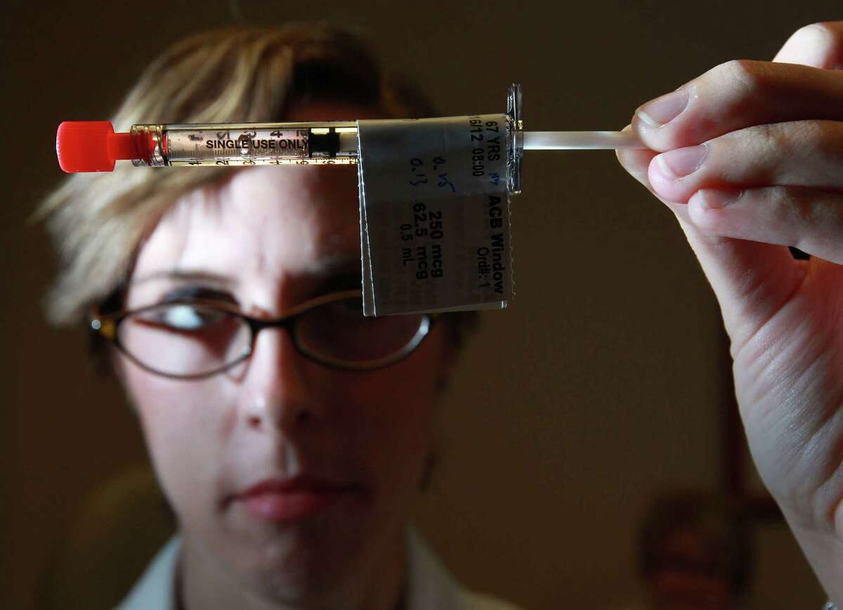 M.D. Anderson nurse Sara Stassen inspects a vaccine that has shown success in decreasing the recurrence of breast cancer.