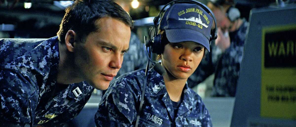 Taylor Kitsch (left) and Rihanna are shown in a scene from "Battleship."