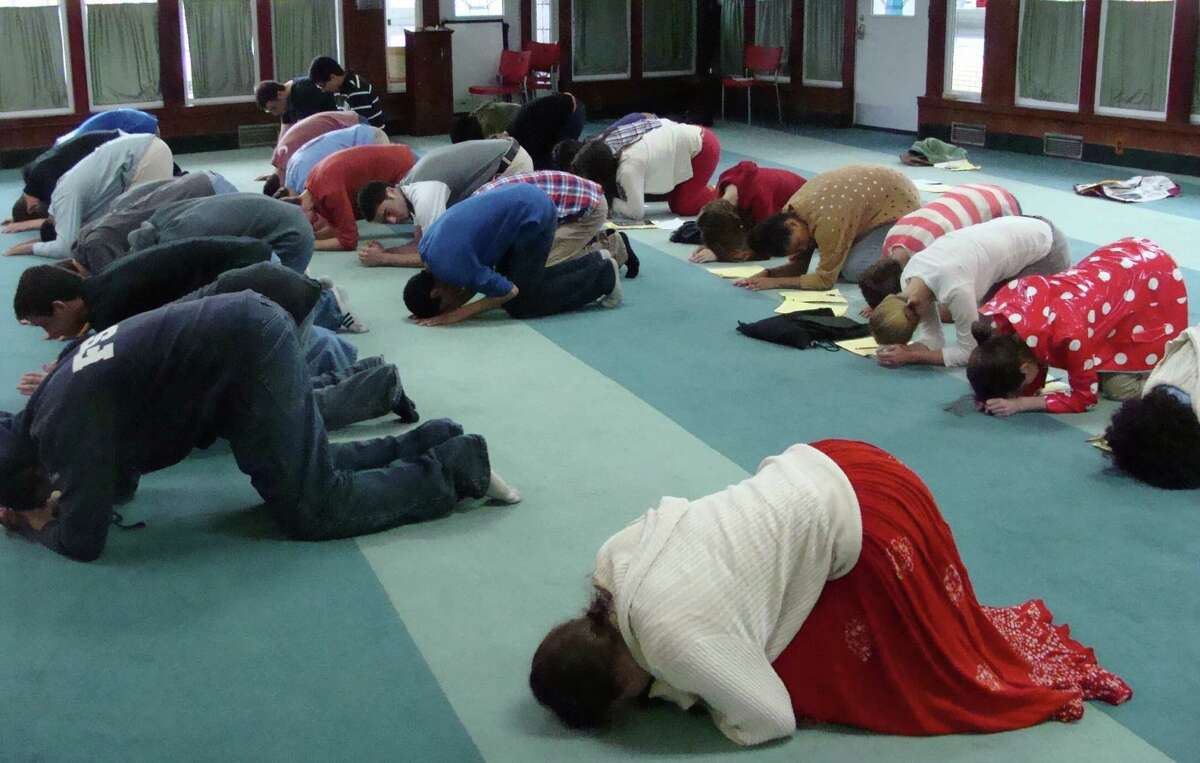 Fairfield Warde High School students visited a mosque in Bridgeport as part of an annual tour of houses of worship Tuesday and while they did not pray, they did follow the actions of those who had gathered for an afternoon prayer.