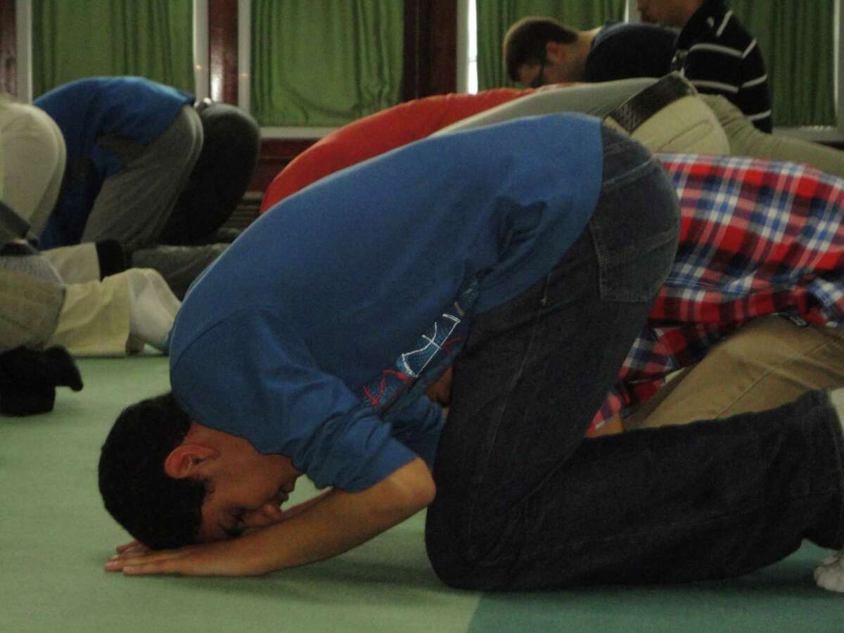 Abdel Abunar, 16, a junior at Fairfield Warde High School, bows deeply at Masjid An-Noor in Bridgeport Tuesday. He and fellow students visited the mosque as part of a religion and social action tour but the house of worship was not unfamiliar to Abunar, who is a Muslim.
