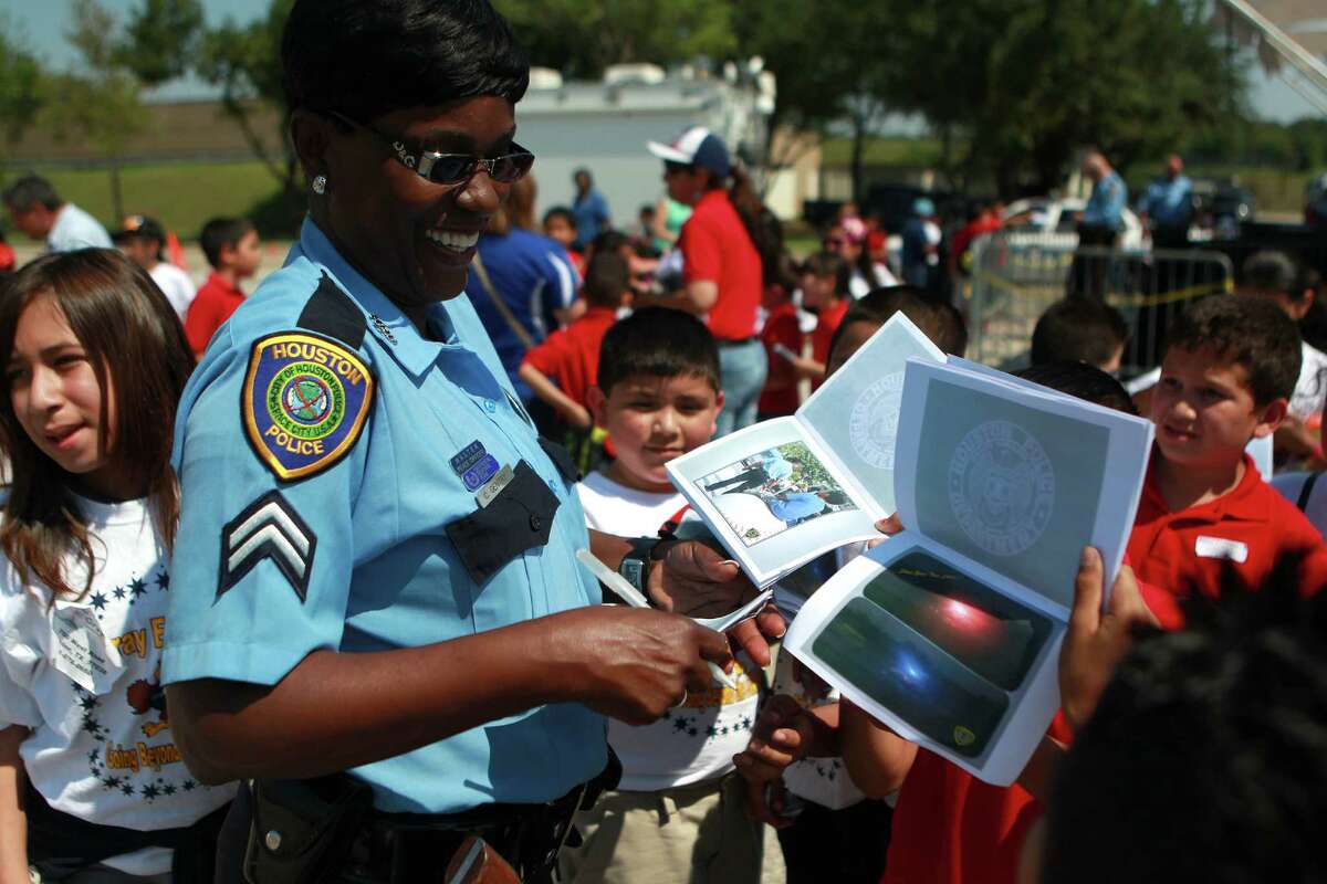 Houston police officer Catherine Gentry signs autographs for a group of elementary school students during the Houston Police Department's annual Police Week events Thursday, May 17, 2012, in Houston. "I feel like a celebrity," Gentry said. "I see how the stars feel."