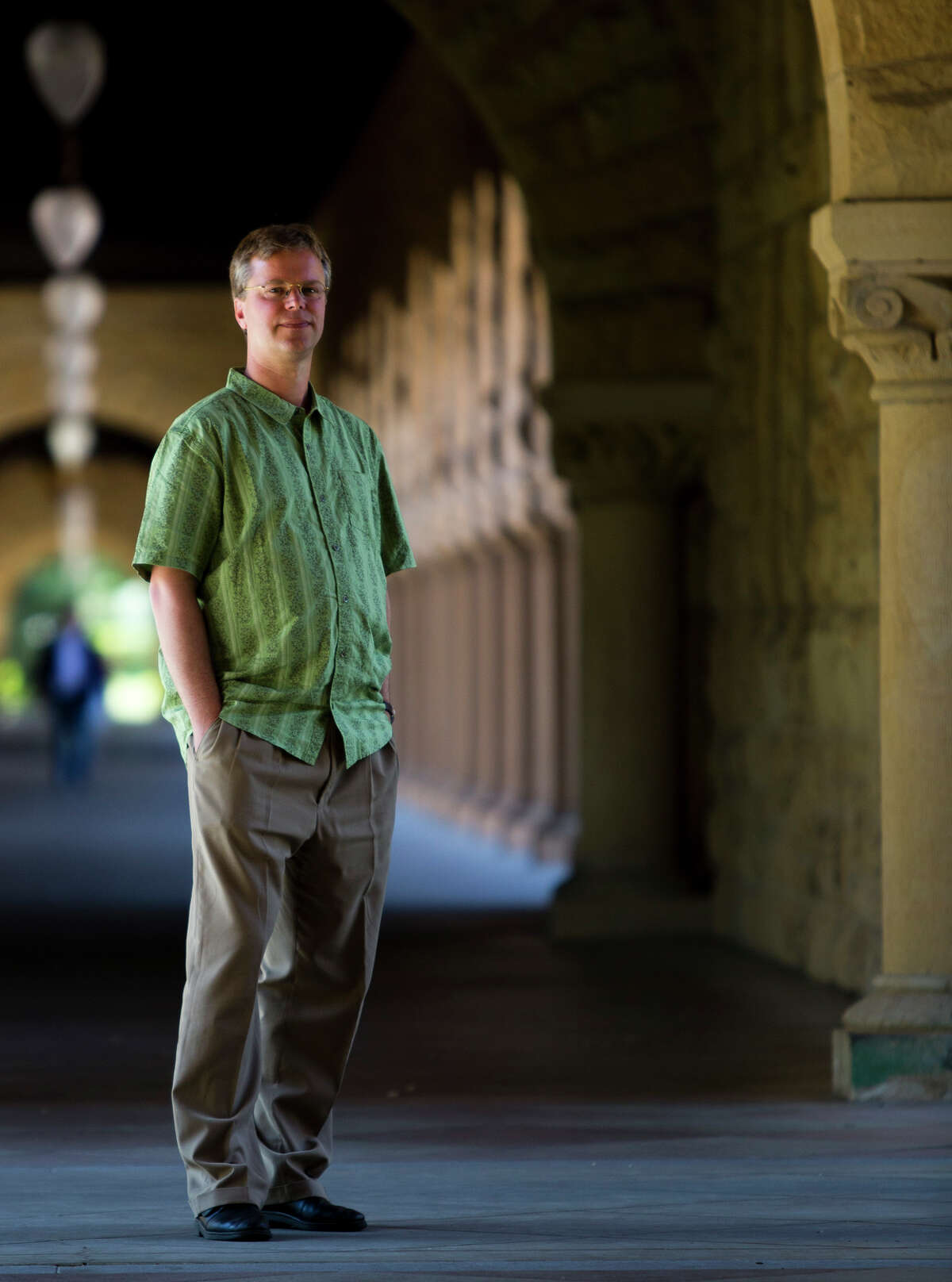Linked-In co-founder Konstantin Guericke stands in a hall at Stanford.