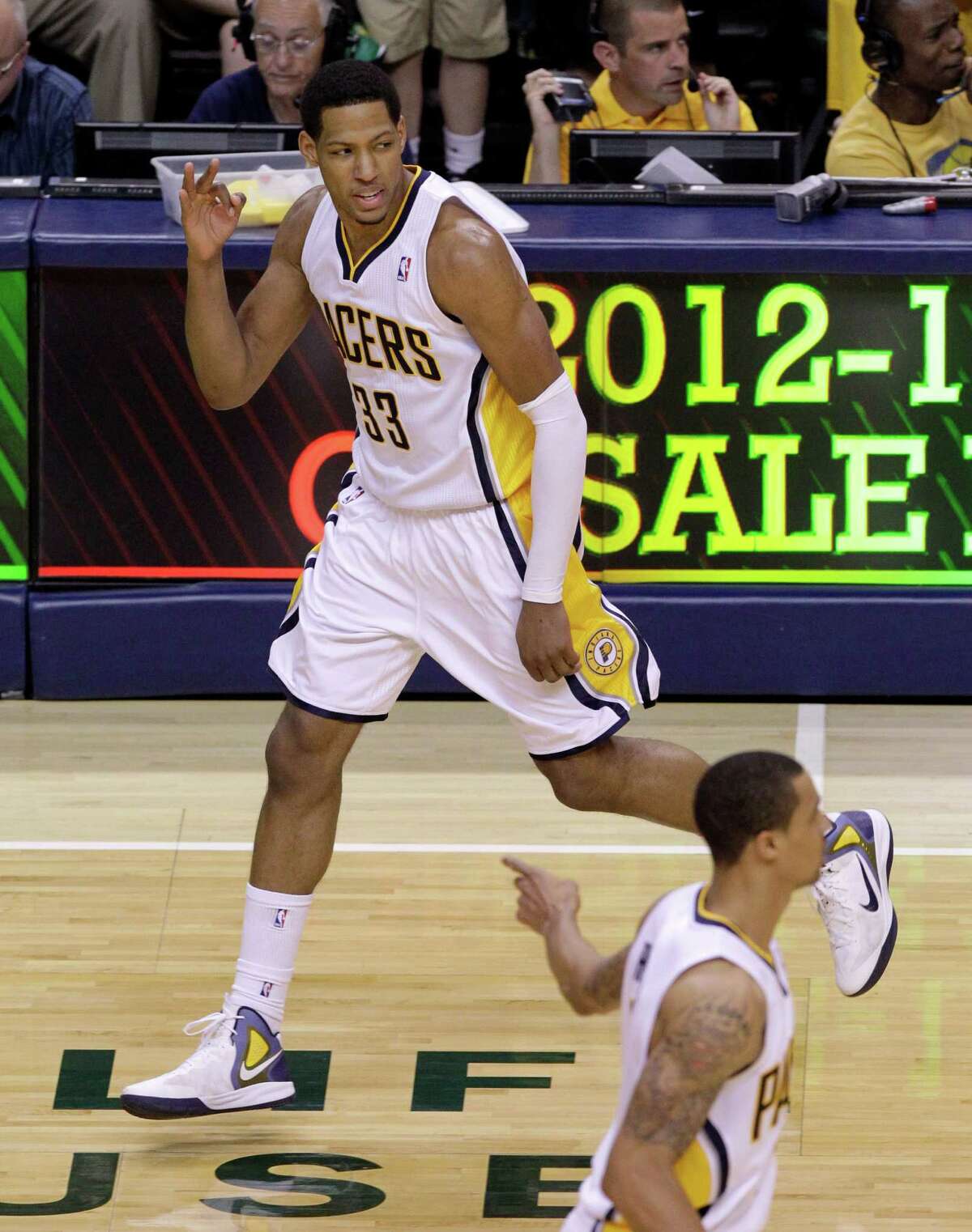 Indiana Pacers forward Danny Granger, top, signals after making a 3-pointer on an assist from shooting guard George Hill, bottom, during the second half of Game 3 against the Miami Heat in their NBA basketball Eastern Conference semifinal playoff series in Indianapolis, Thursday, May 17, 2012. (AP Photo/Michael Conroy)