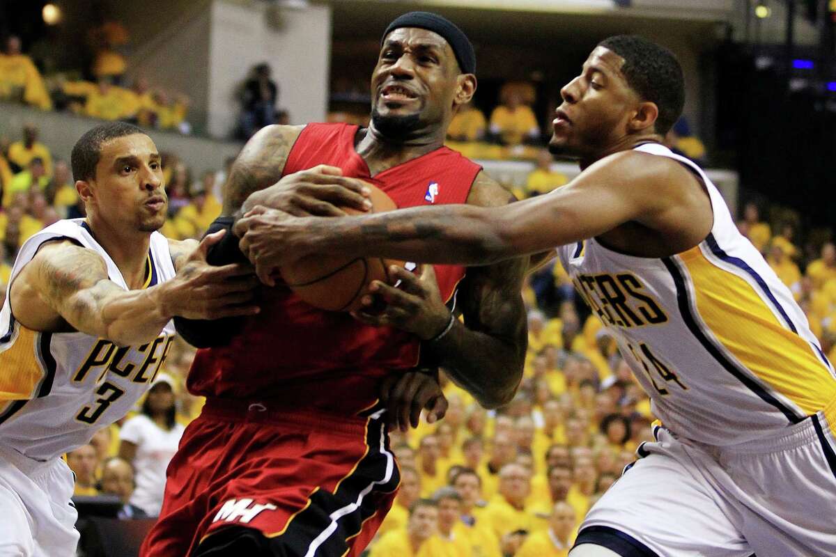 Miami Heat's LeBron James, center, goes to the basket against Indiana Pacers' George Hill (3) and Paul George, right, during the first half of Game 3 of their NBA basketball Eastern Conference semifinal playoff series, Thursday, May 17, 2012, in Indianapolis. The Pacers won, 94-75, to take a 2-1 series lead. (AP Photo/Darron Cummings)