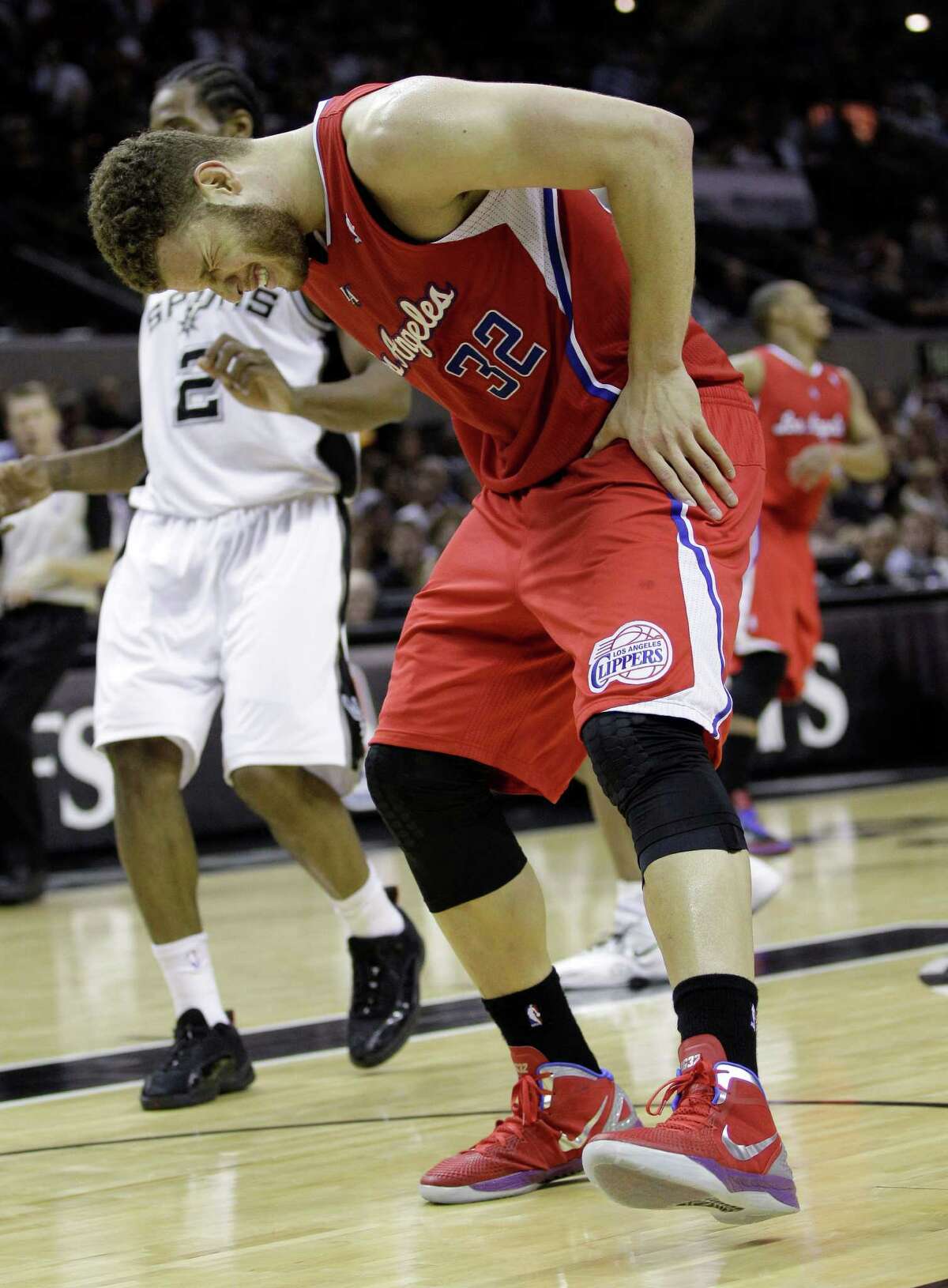 Los Angeles Clippers' Blake Griffin holds his leg during the fourth quarter of Game 2 of an NBA basketball Western Conference semifinal playoff series against the San Antonio Spurs, Thursday, May 17, 2012, in San Antonio. San Antonio won 105-88. (AP Photo/Eric Gay)