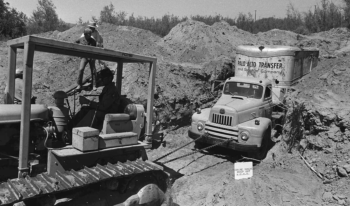 FILE - In this July 20, 1976 file photo, officials remove a truck buried at a rock quarry in Livermore, Calif., in which 26 Chowchilla school children and their bus driver, Ed Ray were held captive. Ray, the school bus driver hailed as a hero for helping 26 students escape after three men kidnapped the group and buried the entire bus underground in 1976 died on Thursday, May 17, 2012. He was 91. (AP Photo, File)