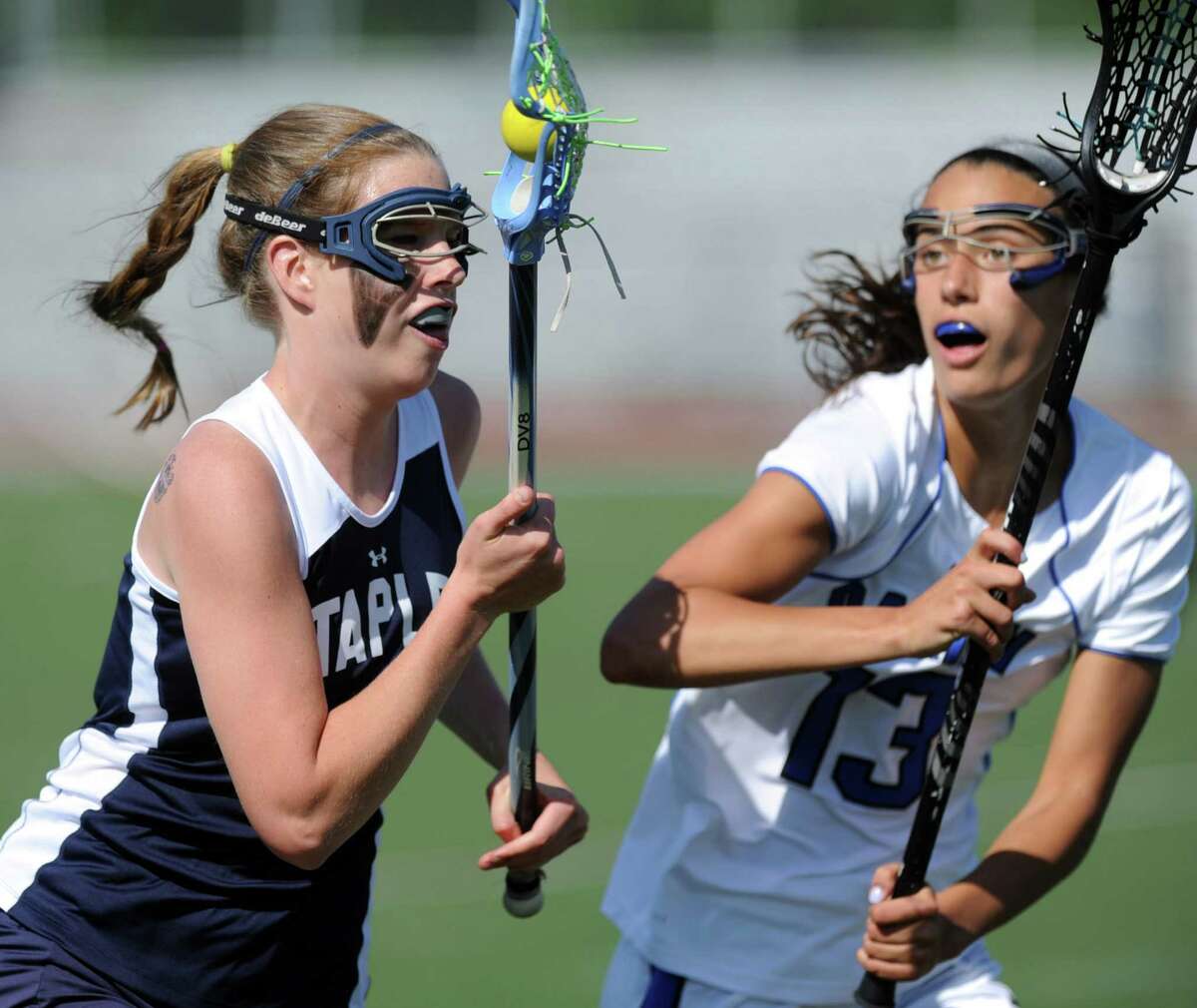 Staples' Adele Mackey controls the ball as she is defended by Darien's Cammie Kirby during Friday's FCIAC quarterfinal game at Darien High School on May 18, 2012.
