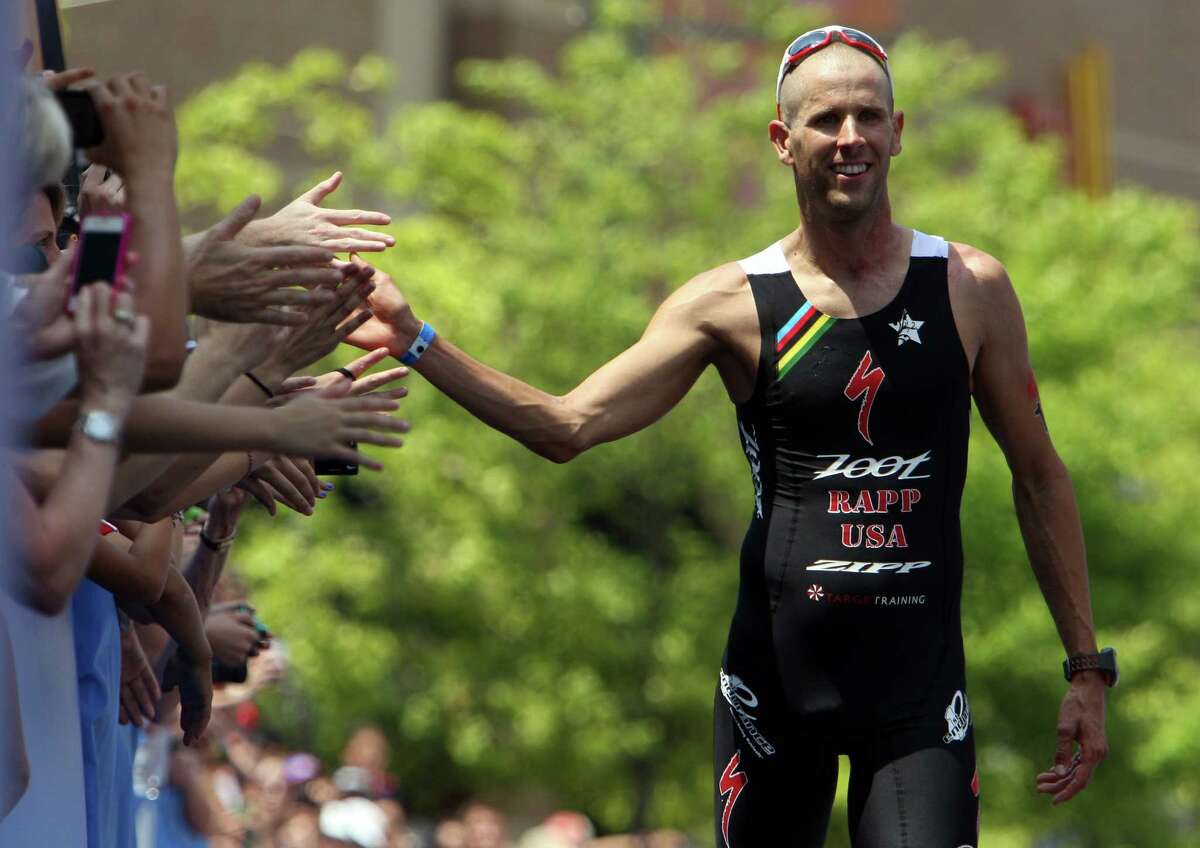 Jordan Rapp celebrates with the crowd before winning the Memorial Hermann Ironman Texas triathlon Saturday, May 19, 2012, in The Woodlands.