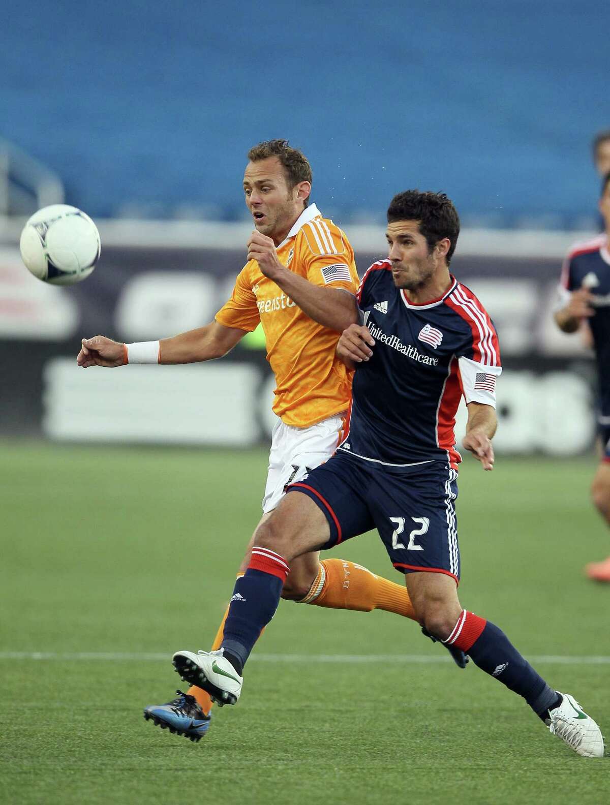 FOXBORO, MA - MAY 19: Brad Davis #11 of the Houston Dynamo and Benny Feilhaber #22 of the New England Revolution fight for the ball in the first half on May 19, 2012 at Gillette Stadium in Foxboro, Massachusetts.