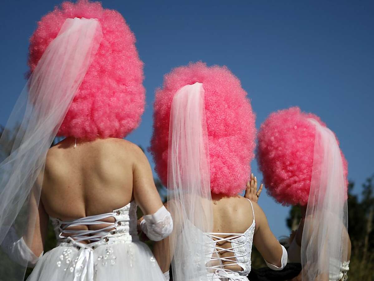 3 brides with giant pink wigs make their way through Golden Gate Park on Sunday. Thousands of runners ranging from the outlandishly dressed to the hardly dressed and not dressed at all made their way through San Francisco on Sunday for the 103rd annual Bay to Breakers marathon.