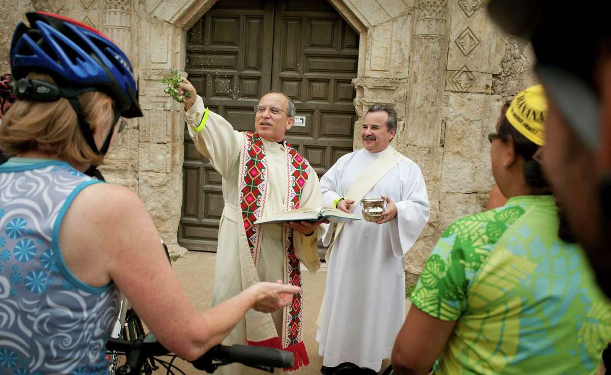 Father David Garcia blesses bicycles and riders with holy water, Sunday, May 20, 2012, at Mission Concepcion in San Antonio.