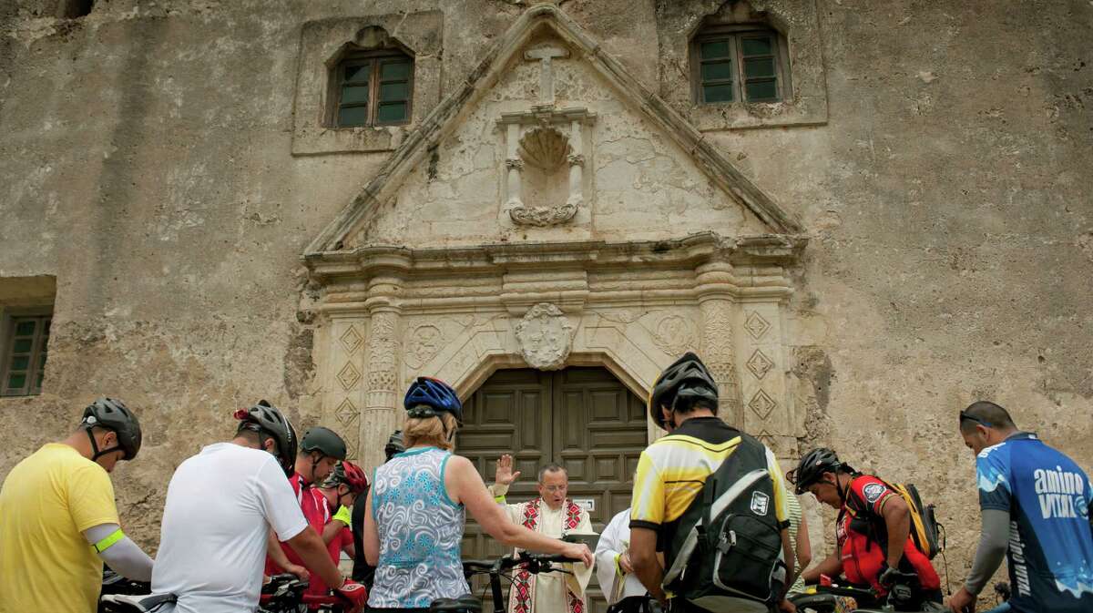 Father David Garcia blesses bicycles and riders, Sunday, May 20, 2012, at Mission Concepcion in San Antonio.
