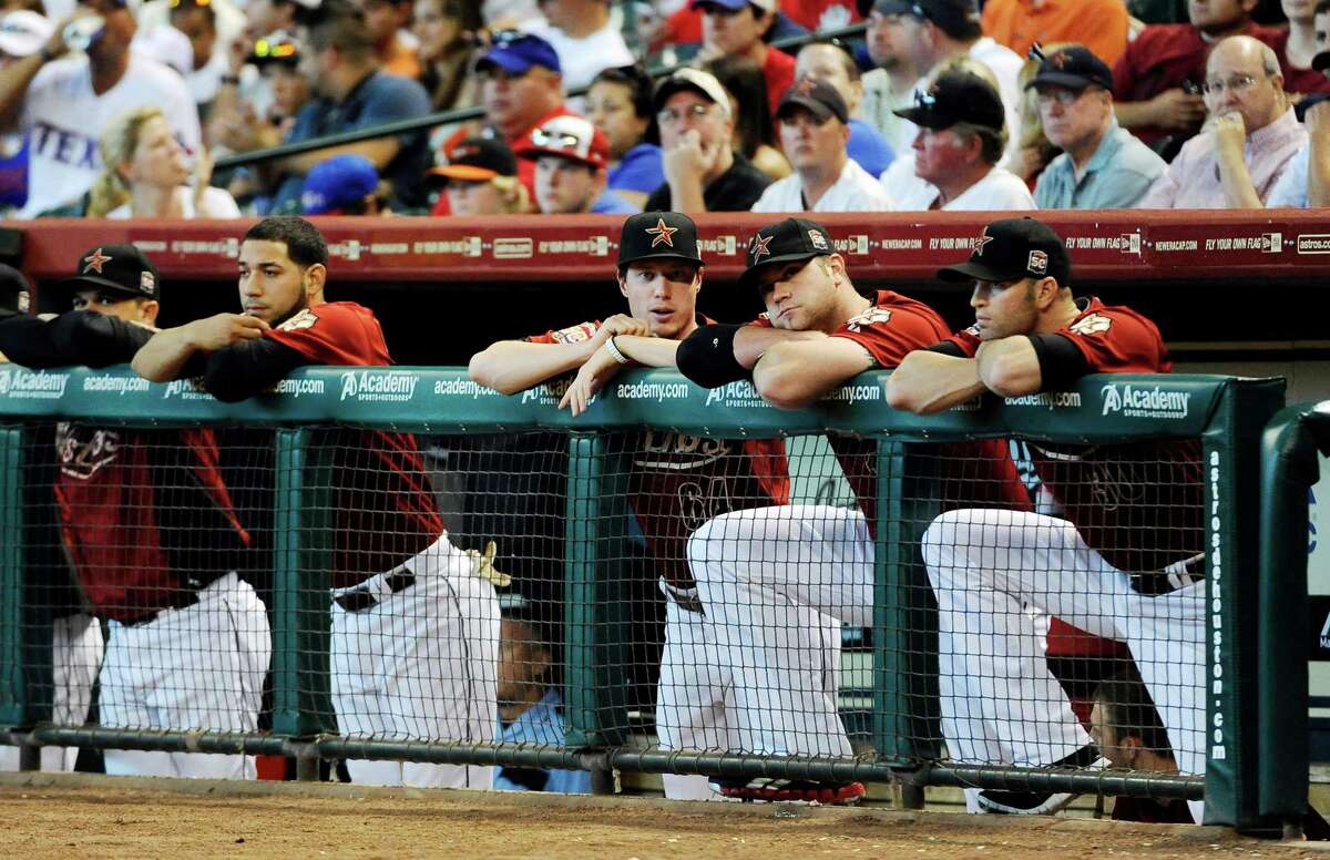 Houston Astros players watch the first inning of an interleague baseball game against the Texas Rangers, Sunday, May 20, 2012, in Houston. The Rangers scored five runs in the first on their way to a 6-1 win. (AP Photo/Pat Sullivan)
